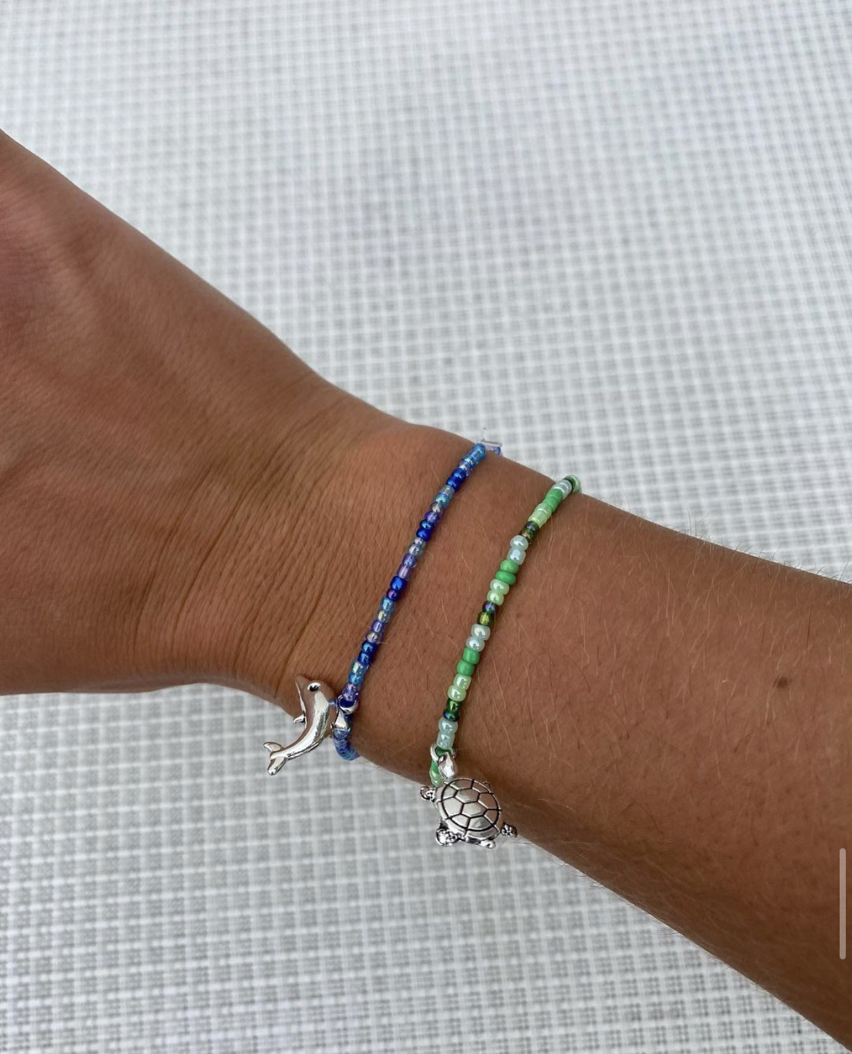 Sophia Beech's bracelet are simple and delicate, often adorned with one small charm, many of which are beach-themed.