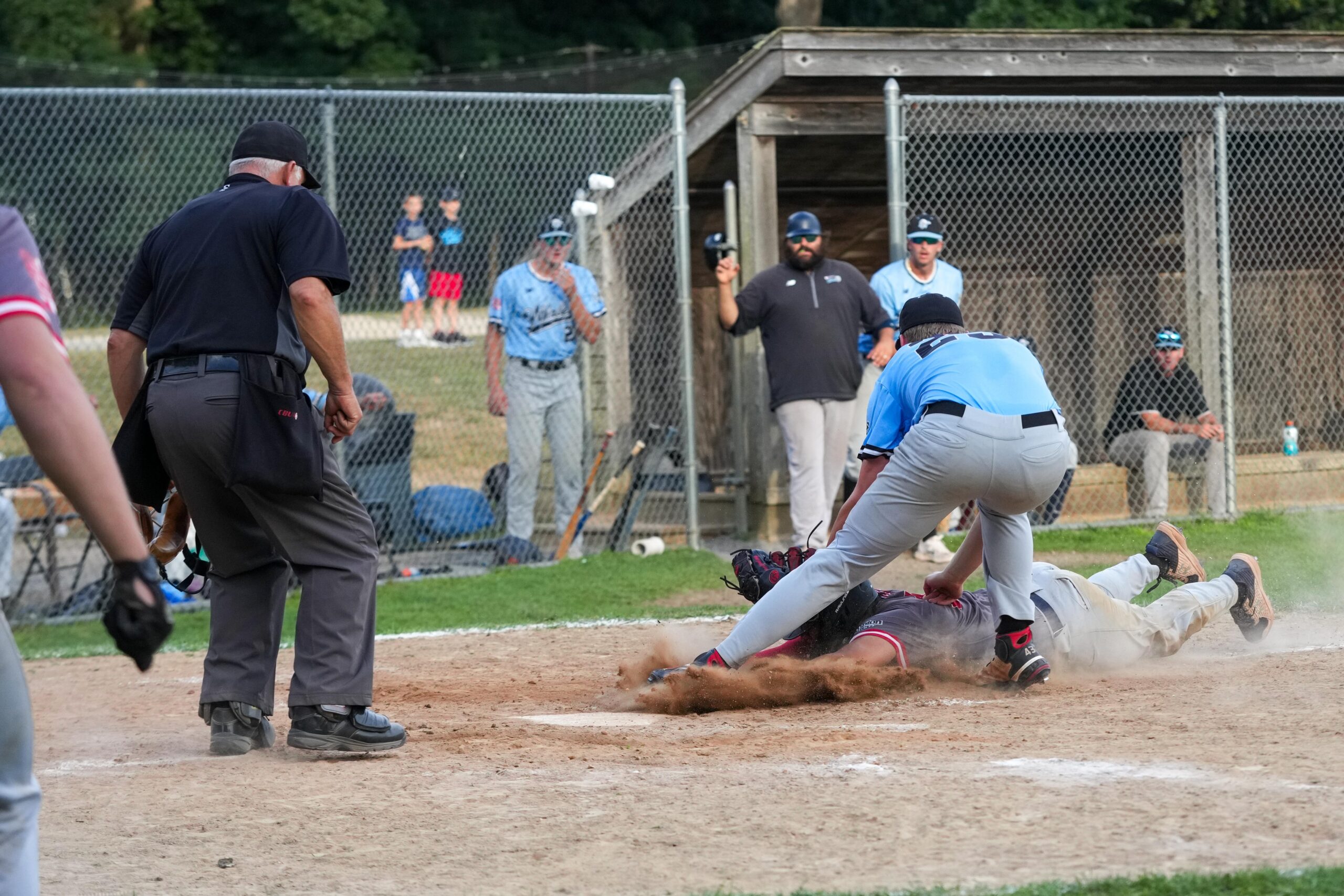 Whaler Brett Borcherding (Rose-Hulman IT) tags out Aviator Mason Wolf (Monmouth) trying to score on a wild pitch in the top of the ninth.   RON ESPOSITO