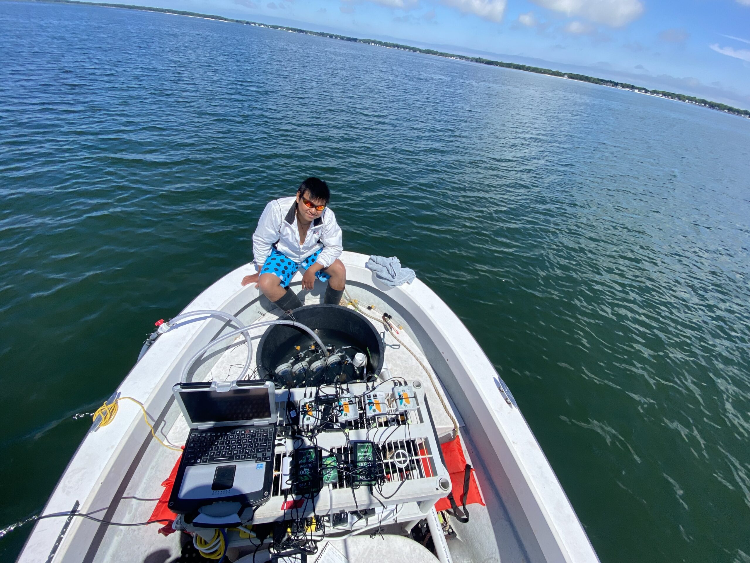Stony Brook researcher Lucas Wong with the field laboratory equipment he and research partner Jessica MacGregor use to study the respiration of bay scallops in the Peconics to gauge how much physiological stress they are experiencing from various environmental factors.