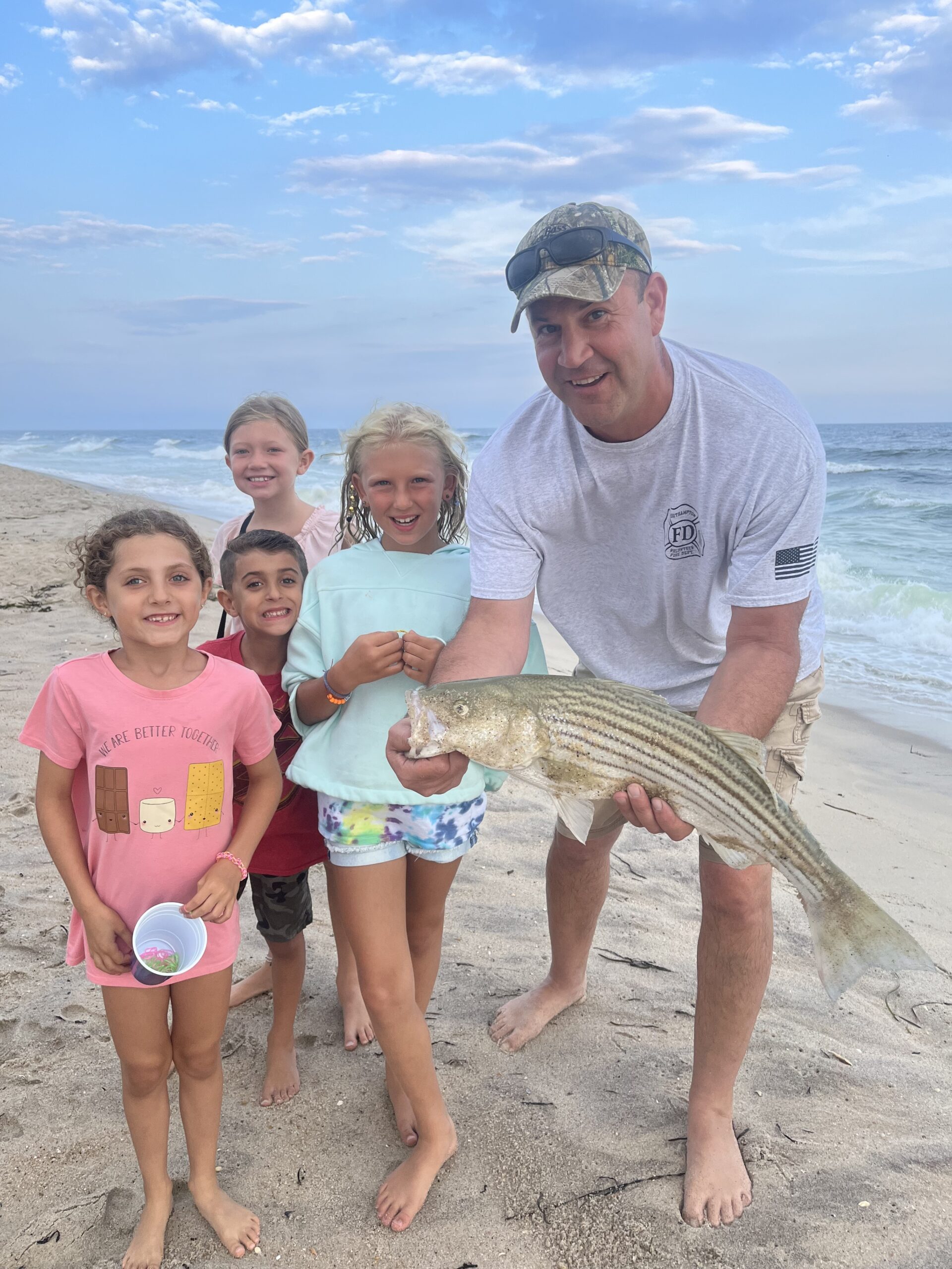 Nadia Almansa, Gabe Almansa, Maeve LeGuen and Avery Armusewicz got a kick out of seeing Chris Capalbo land this schoolie striped bass from the beach in Southampton recently.