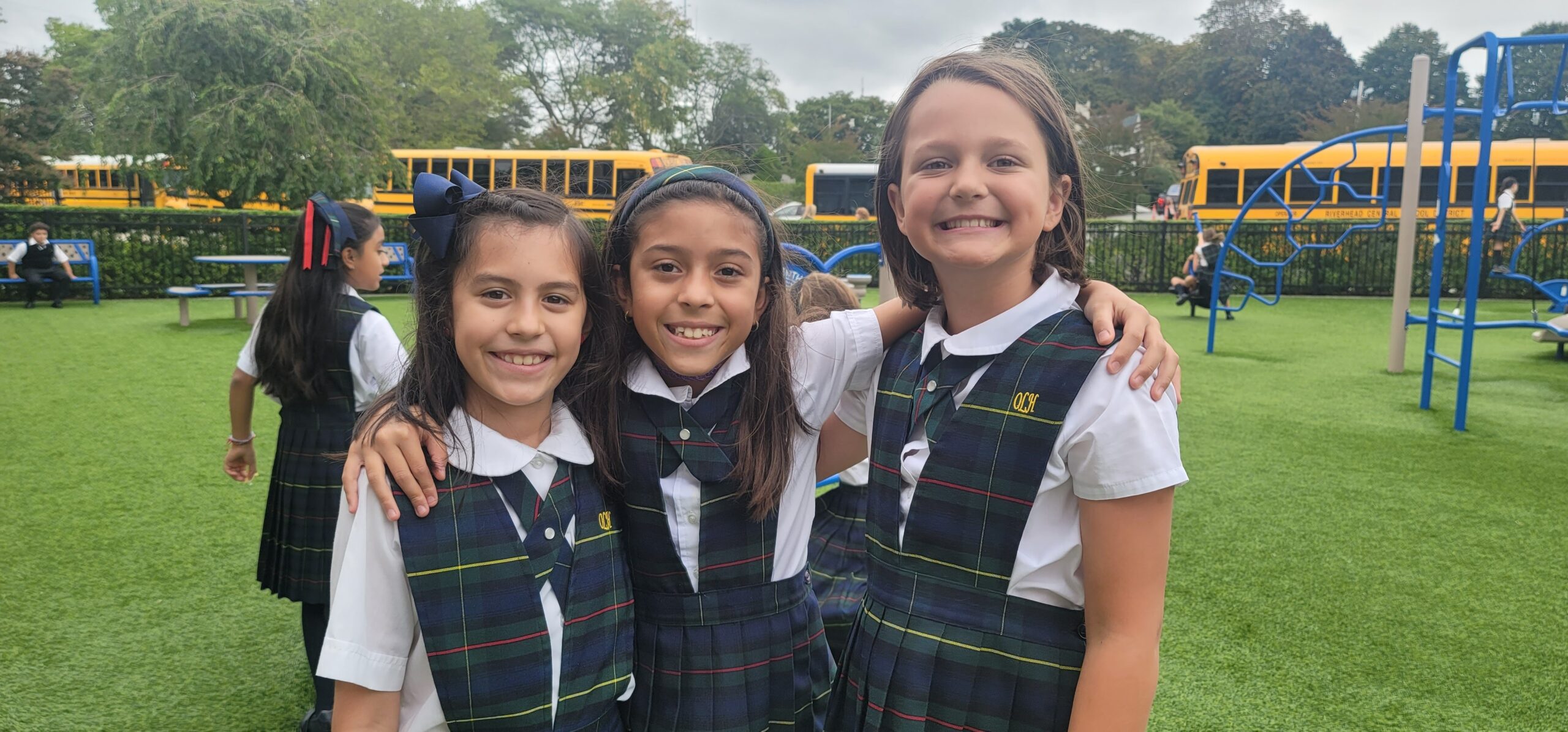 Our Lady of the Hamptons School fourth-graders, from left, Aurbree Gutierrez, Nicole Cardona and Helena Gredysa, enjoy a summer day on the playground. COURTESY OUR LADY OF THE HAMPTONS