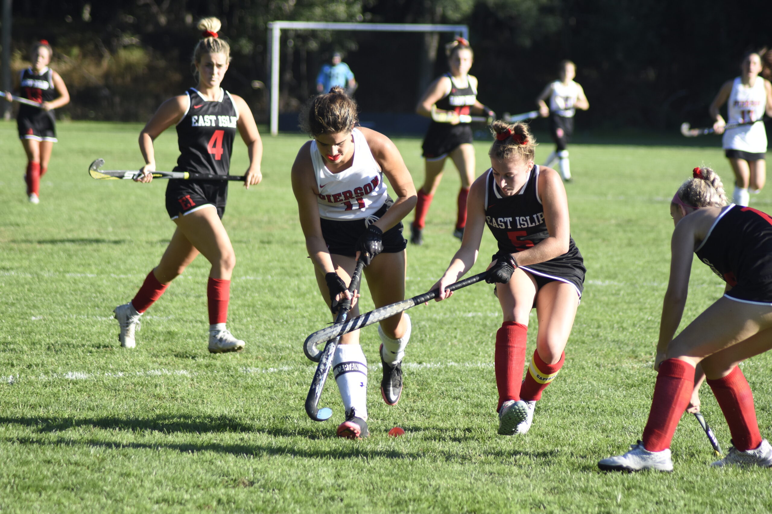A pair of captains, including Pierson's Meredith Spolarich, go after a loose ball.    DREW BUDD
