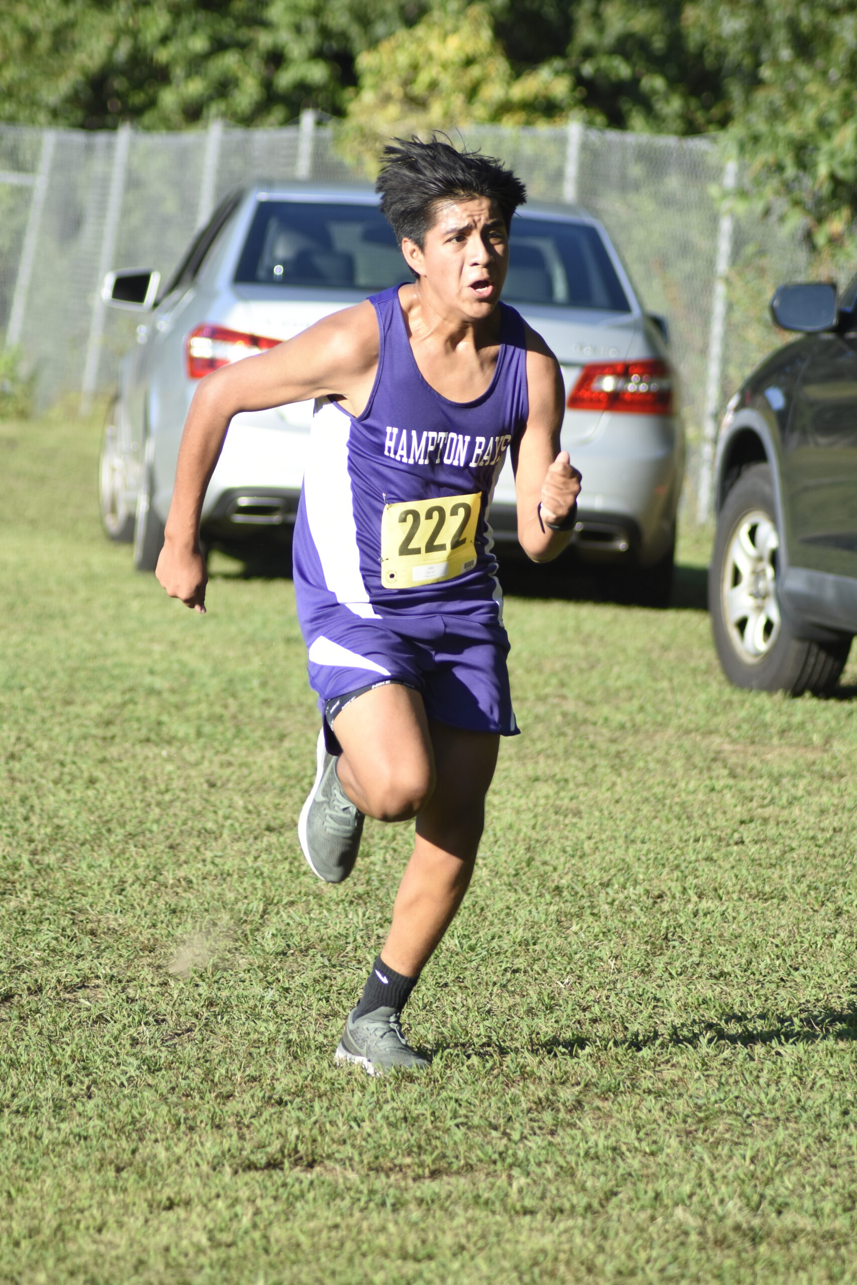 Israel Pulla of Hampton Bays crosses the finish line of the varsity boys race at the Peconic Invitational on September 15.    DREW BUDD