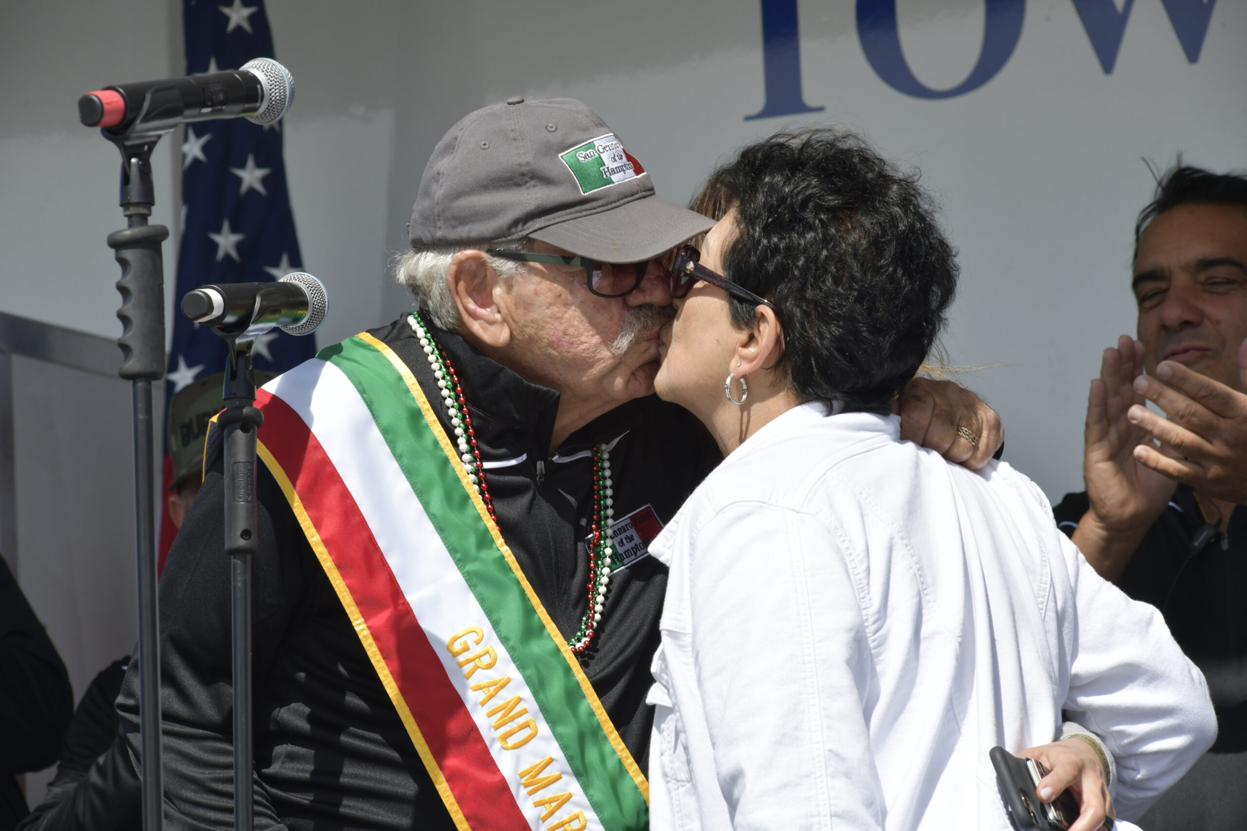 San Gennaro Grand Marshal Phil Forte kisses his wife, Carolyn at the San Gennaro Feast of Hamptons on Saturday,