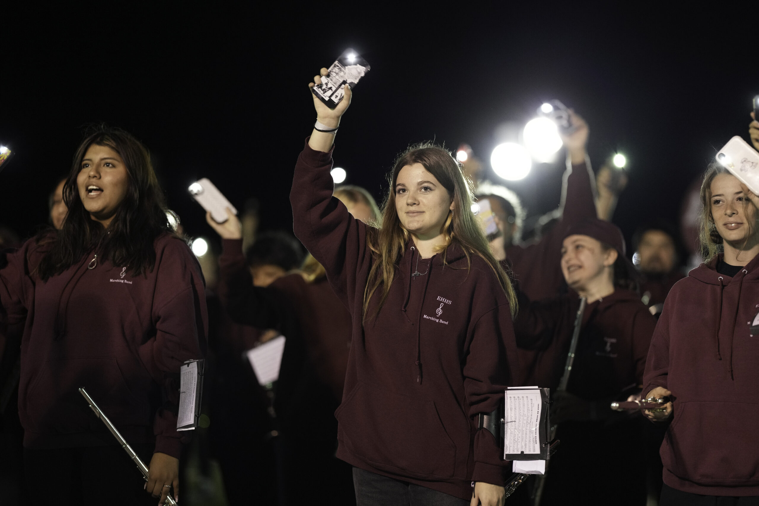 Members of the East Hampton Marching Band hold up their phones during their rendition of West Virginia during halftime.    RON ESPOSITO