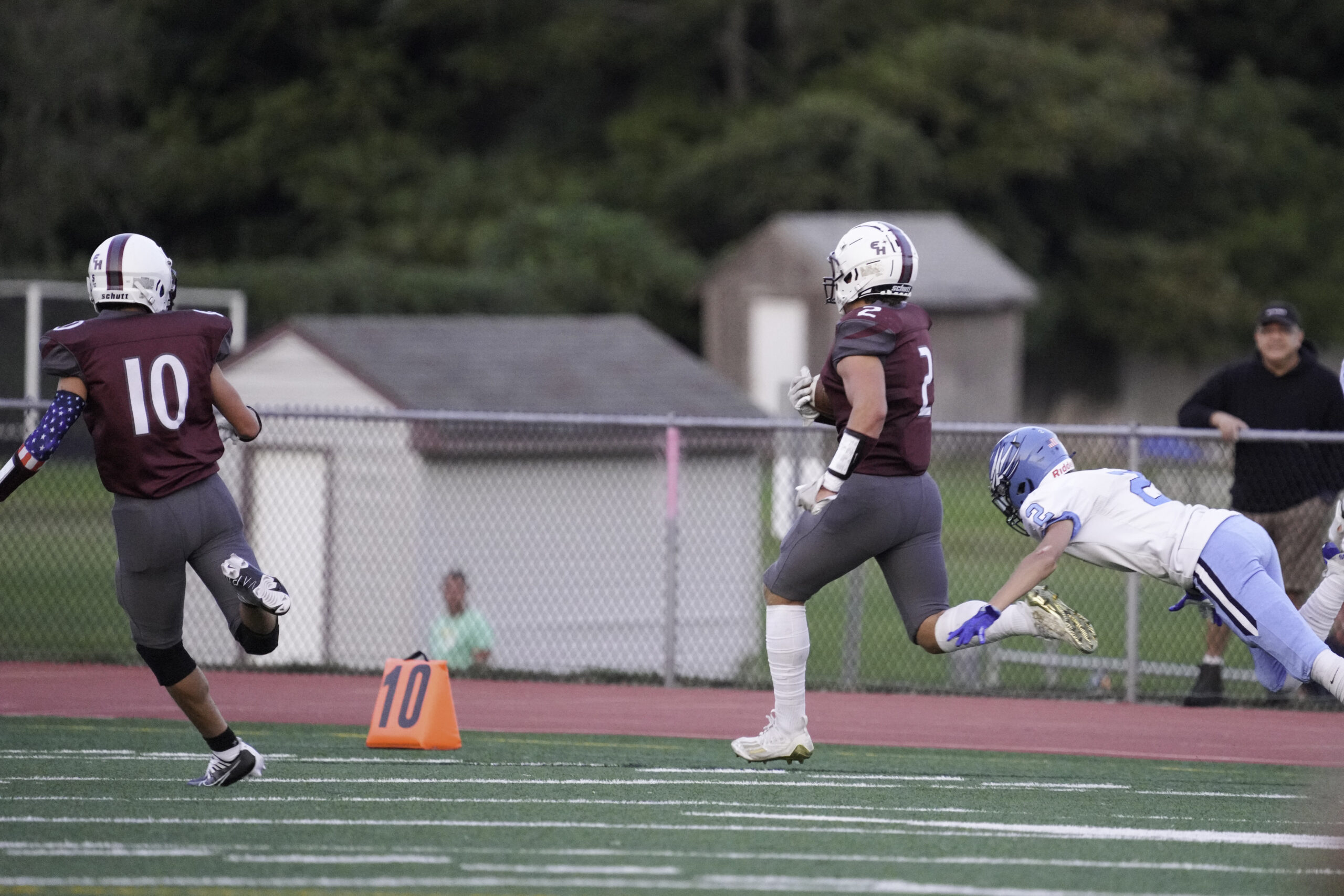 Finn Byrnes makes the final Rocky Point defender miss to cap a 99-yard touchdown run, the first play of scrimmage for the East Hampton offense on Saturday night.    RON ESPOSITO