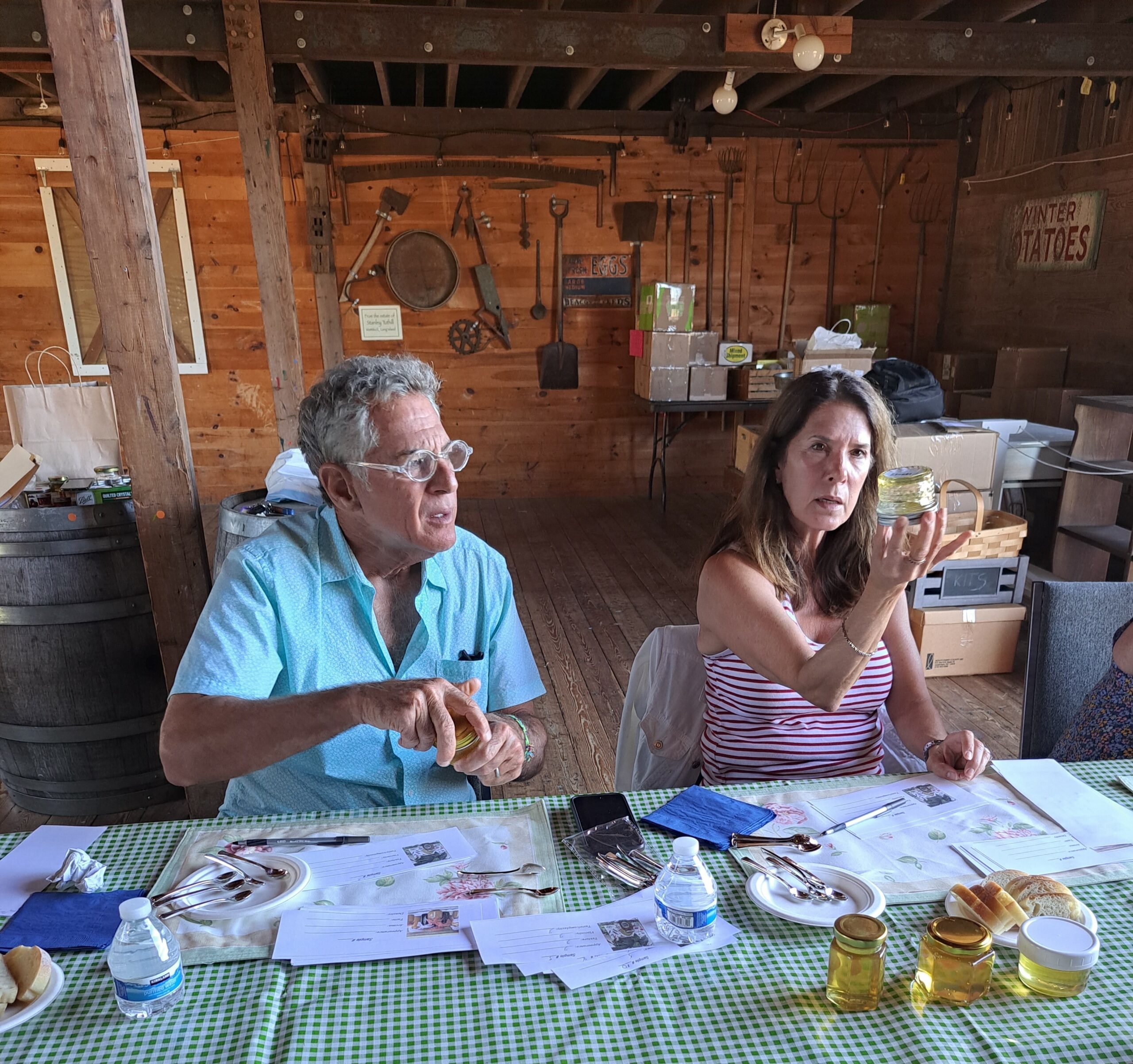 Bill Ritter and his wife, Kathleen Friery, evaluate a honey entry during preliminary judging of the Hallockville Museum Farm Jam and Honey Contest in the Naugles Barn at Hallockville. Final judging and winner selection is September 18 at the 41st Hallockville Country Fair and Craft Show.  COURTESY HALLOCKVILLE MUSEUM FARM