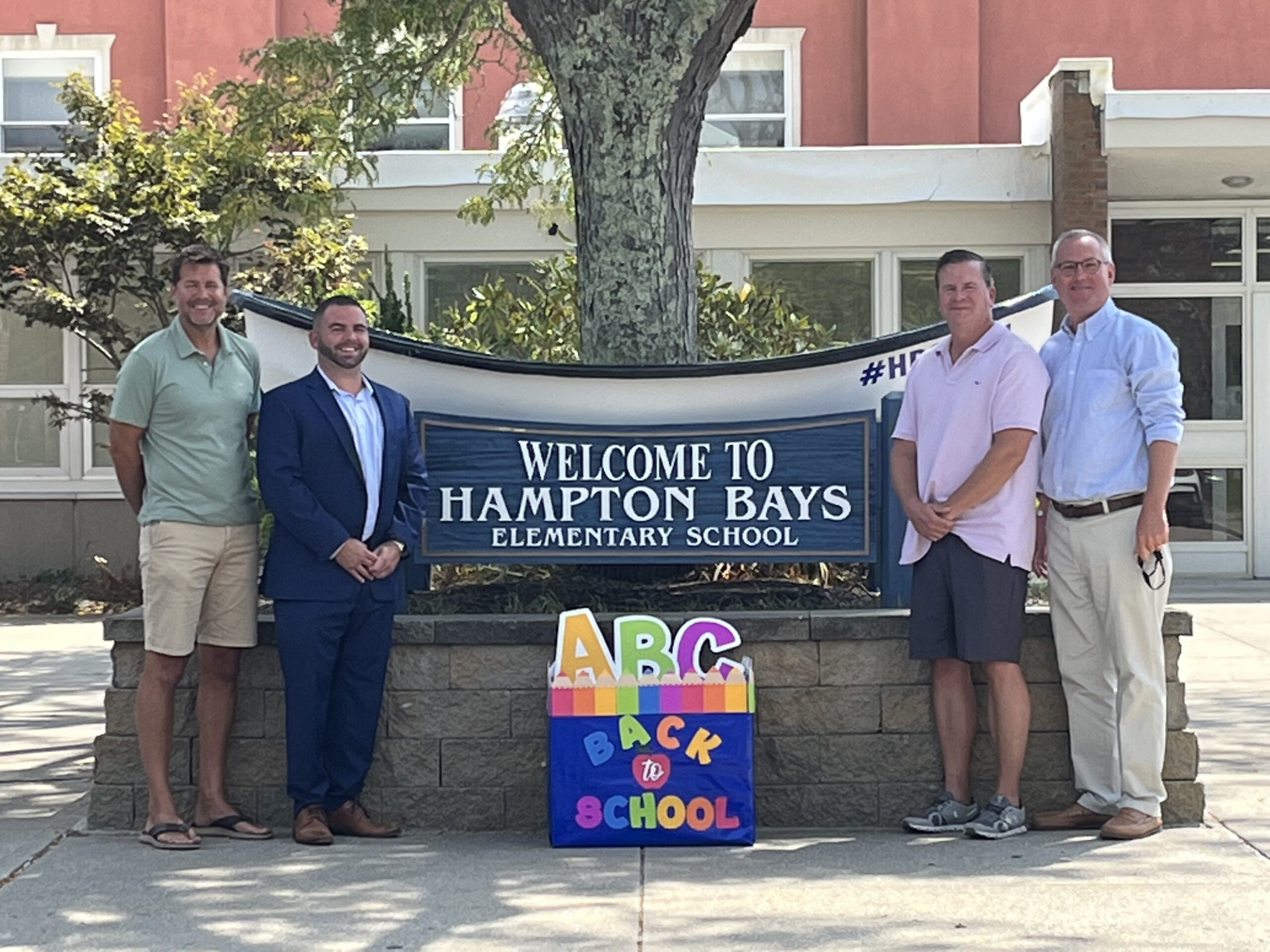 Hampton Bays Elementary School received a bundle of school supplies from Brian Pellone of Allstate Insurance. The donation will be distributed to students in need. From left, Assistant Principal Richard Triandafils, Pellone, Principal Marc Meyer and Superintendent of Schools Lars Clemensen. COURTESY HAMPTON BAYS SCHOOL DISTRICT
