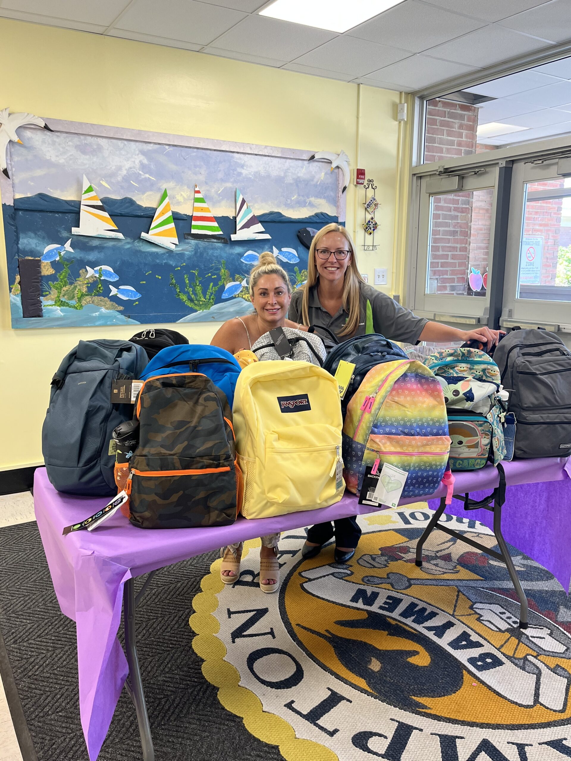Hampton Bays Elementary School recently accepted a donation of 20 backpacks, which will be donated to students in need. Second grade teacher Lori Foster accepted the donation from Maryellen Feretti, TD retail market manager. COURTESY HAMPTON BAYS SCHOOL DISTRICT
