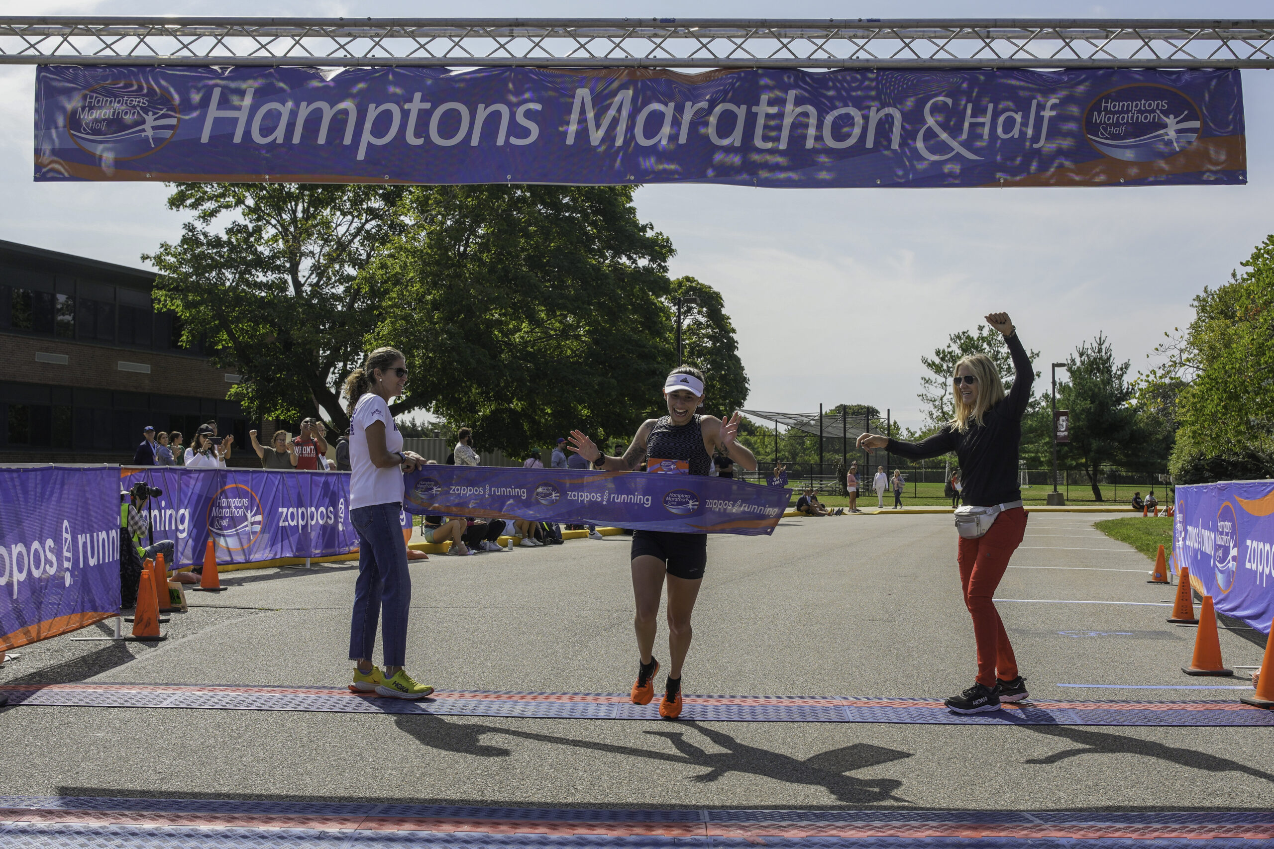 The female champion of marathon, Sarah Cottone, crosses the finish line.       RON ESPOSITO