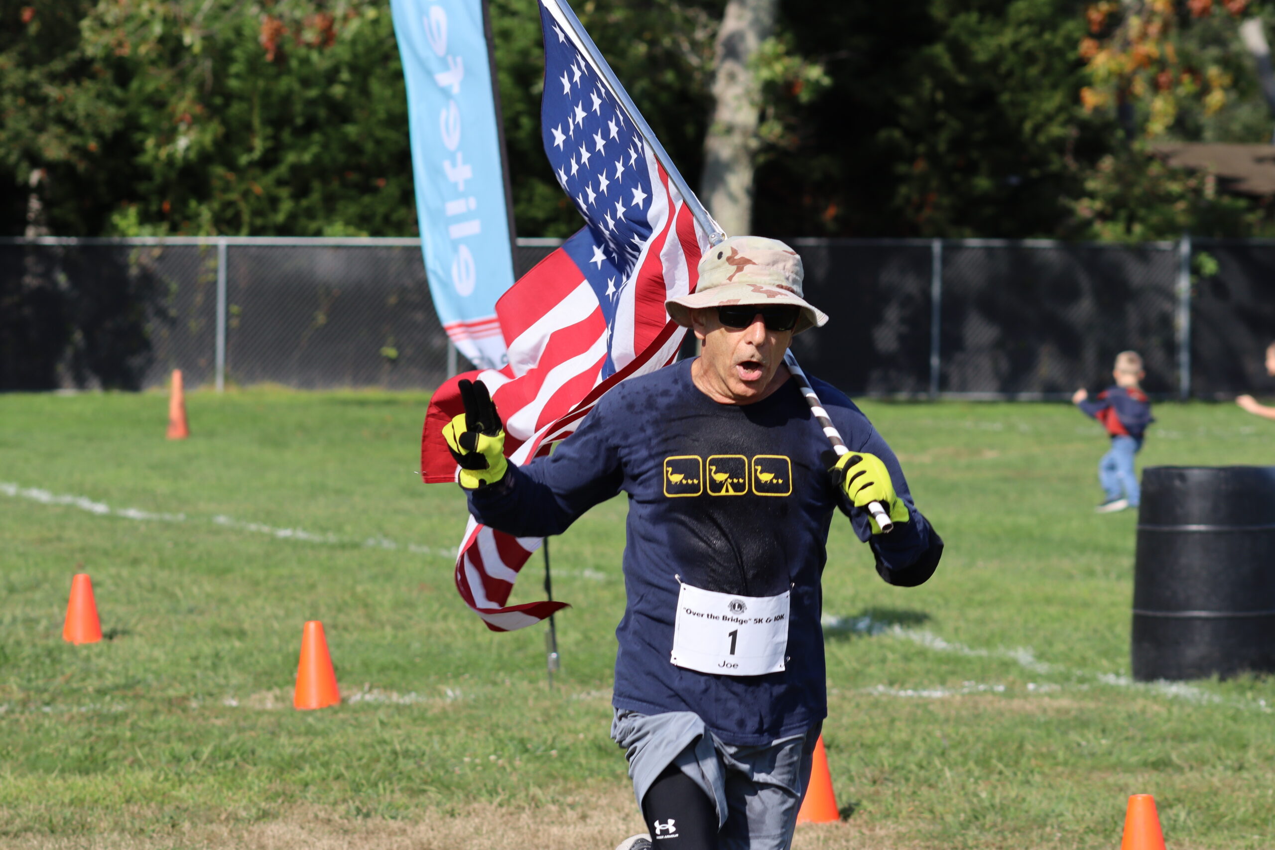 Joe Sferrazza of Manorville ran the 5K with an American flag, to honor veterans. CAILIN RILEY
