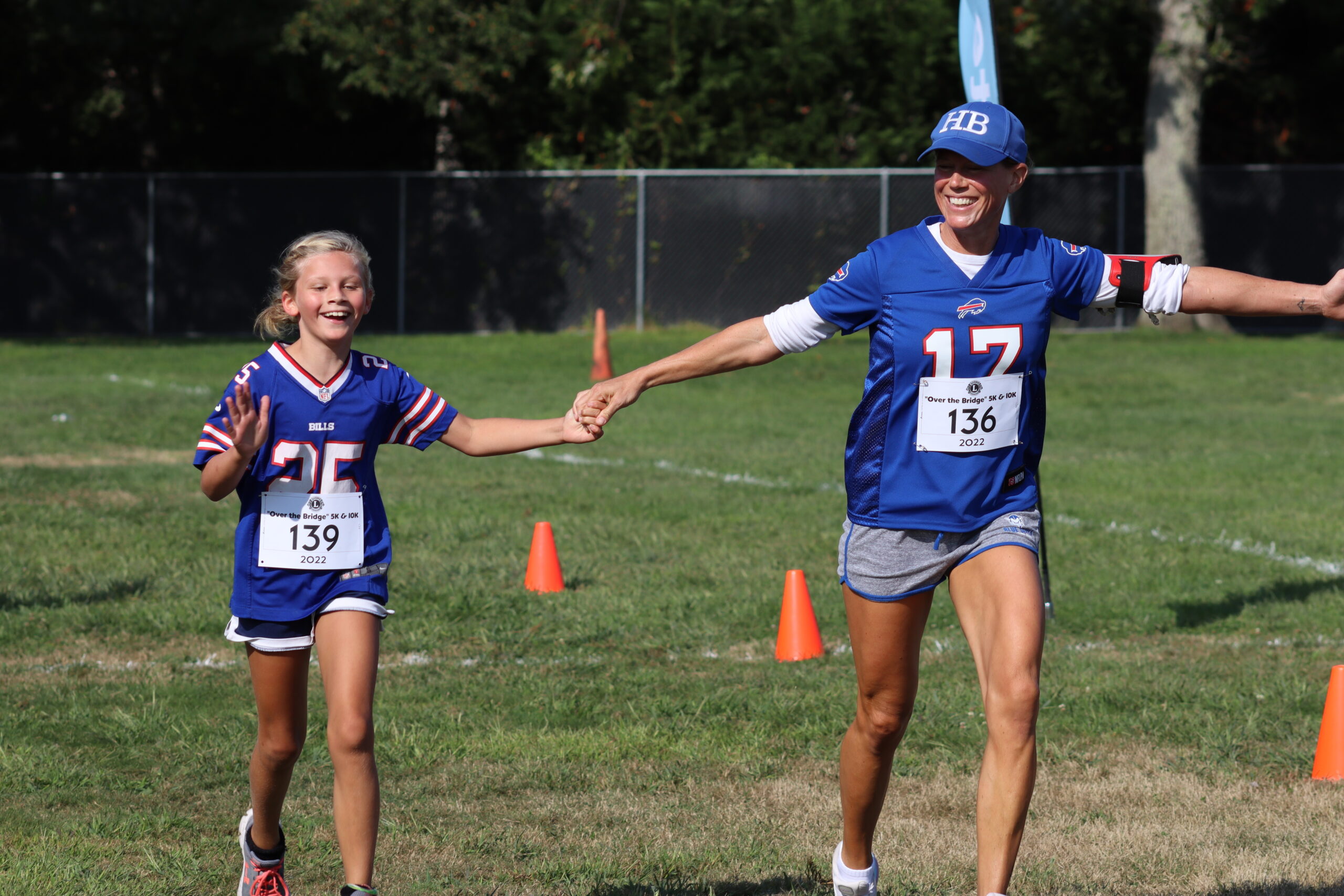 Annabel Ramsey of Hampton Bays, left, crosses the finish line with Jessica Ramsay. CAILIN RILEY