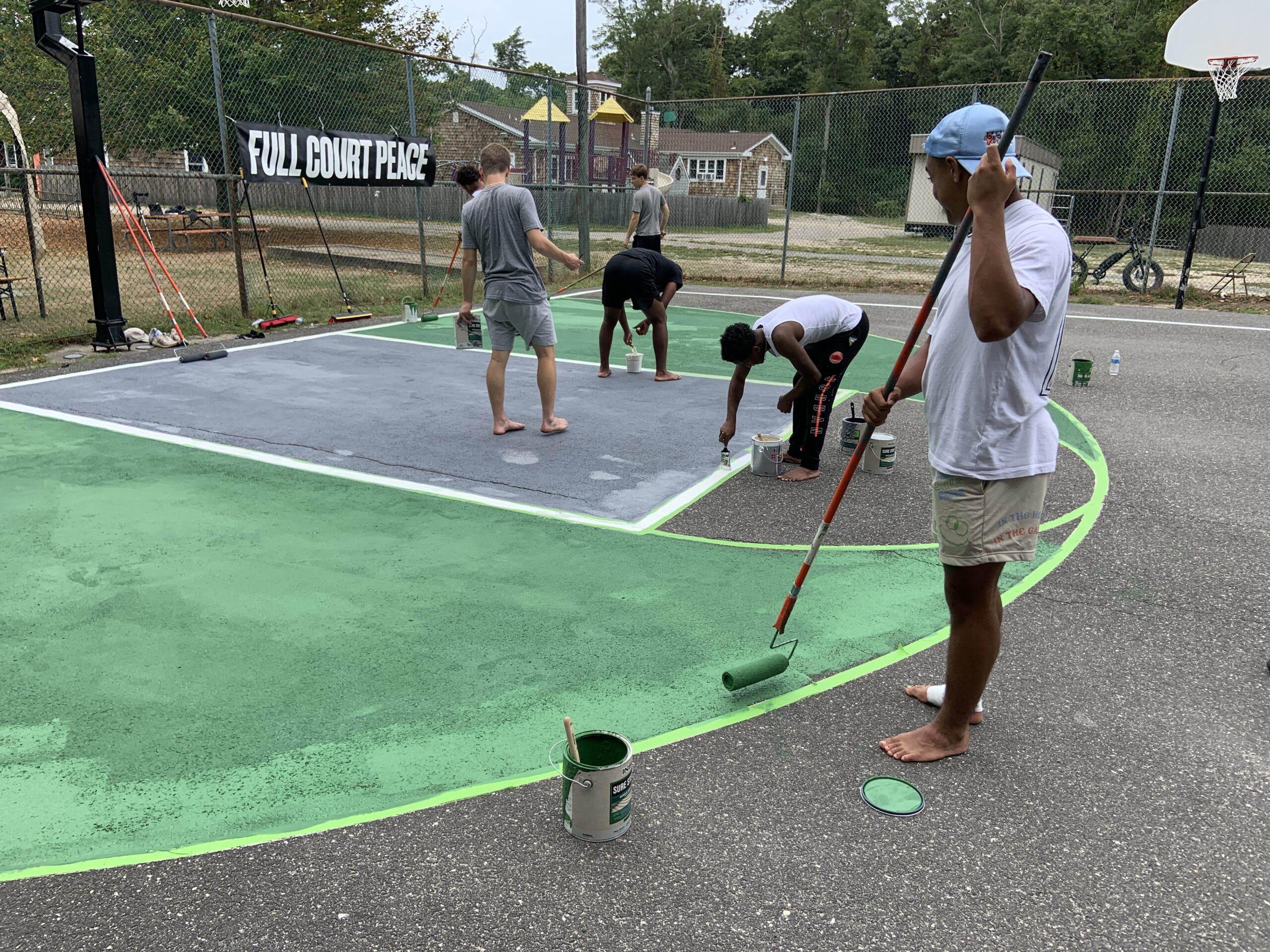 Bridgehampton students helped repaint the basketball court at the Bridgehampton Child Care and Recreational Center on Sunday. STEPHEN J. KOTZ