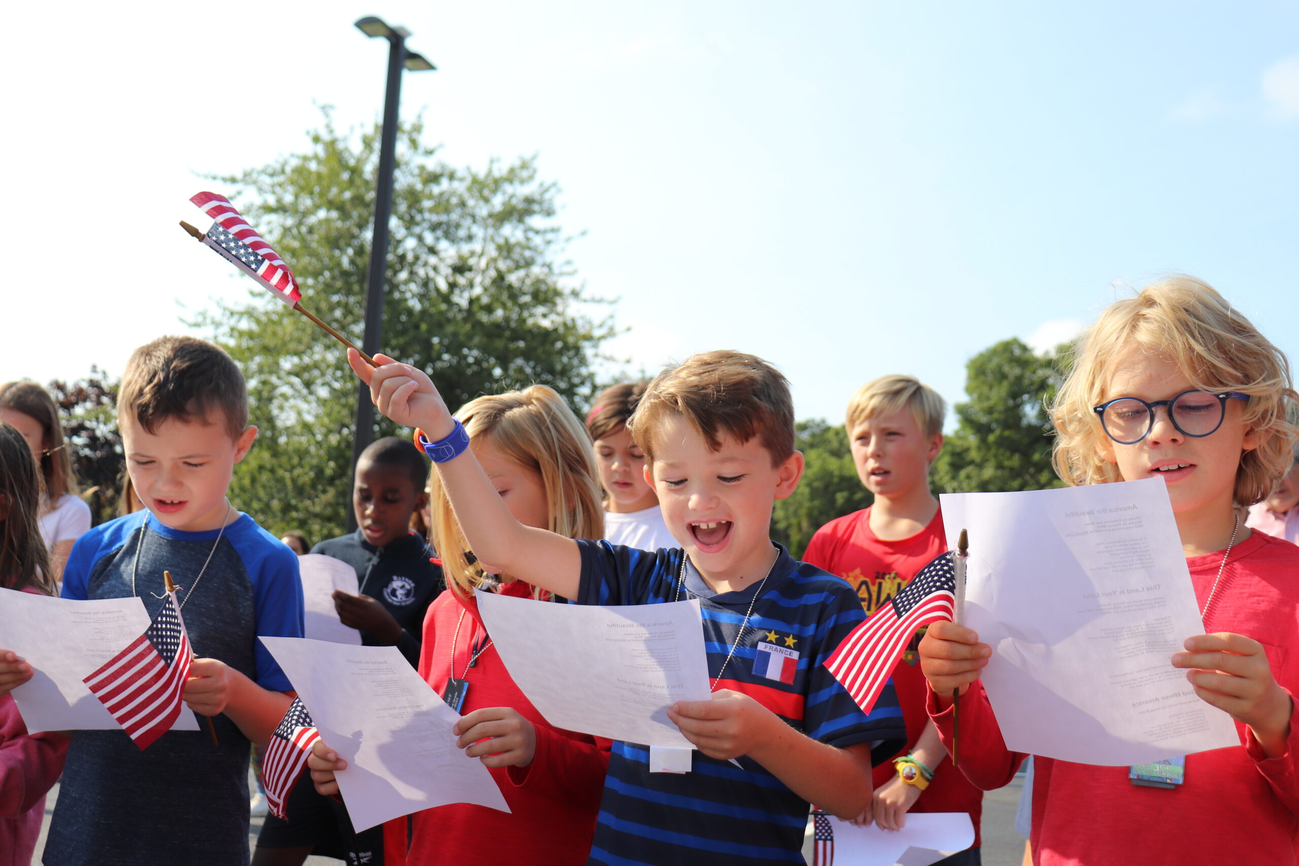 On Friday, September 9, the students, staff, and families of Raynor Country Day School hosted its annual Patriot Day Ceremony to honor the events of September 11. Christopher Lynch and his third-grade classmates sing patriotic songs. COURTESY RAYNOR COUNTRY DAY SCHOOL