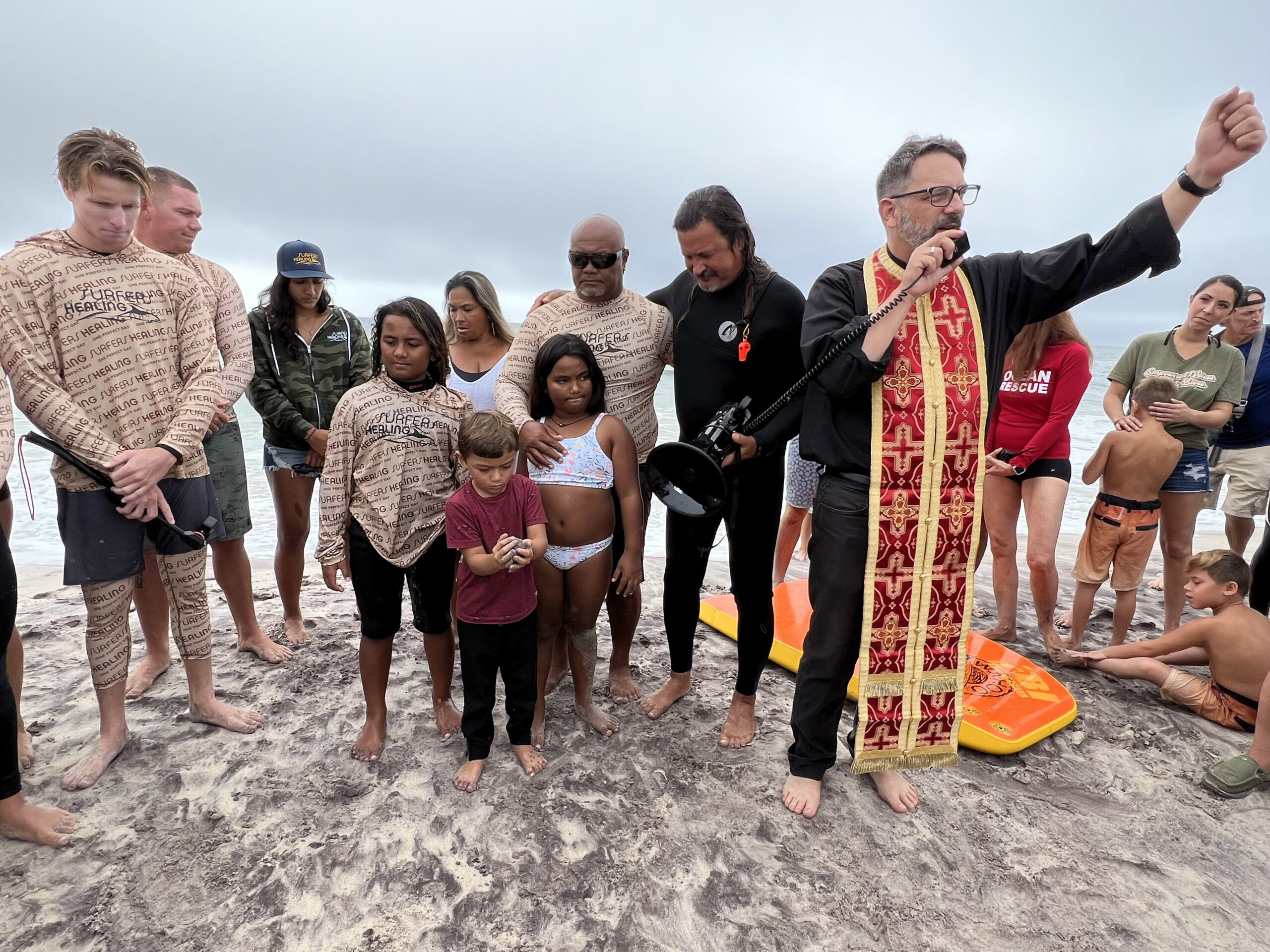 Father Constantine Lazarakis of the Dormition of Virgin Mary Greek Orthodox Church of the Hamptons  offers a prayer at Surfers for Healing at Ponquogue Beach on September 14.  DANA SHAW