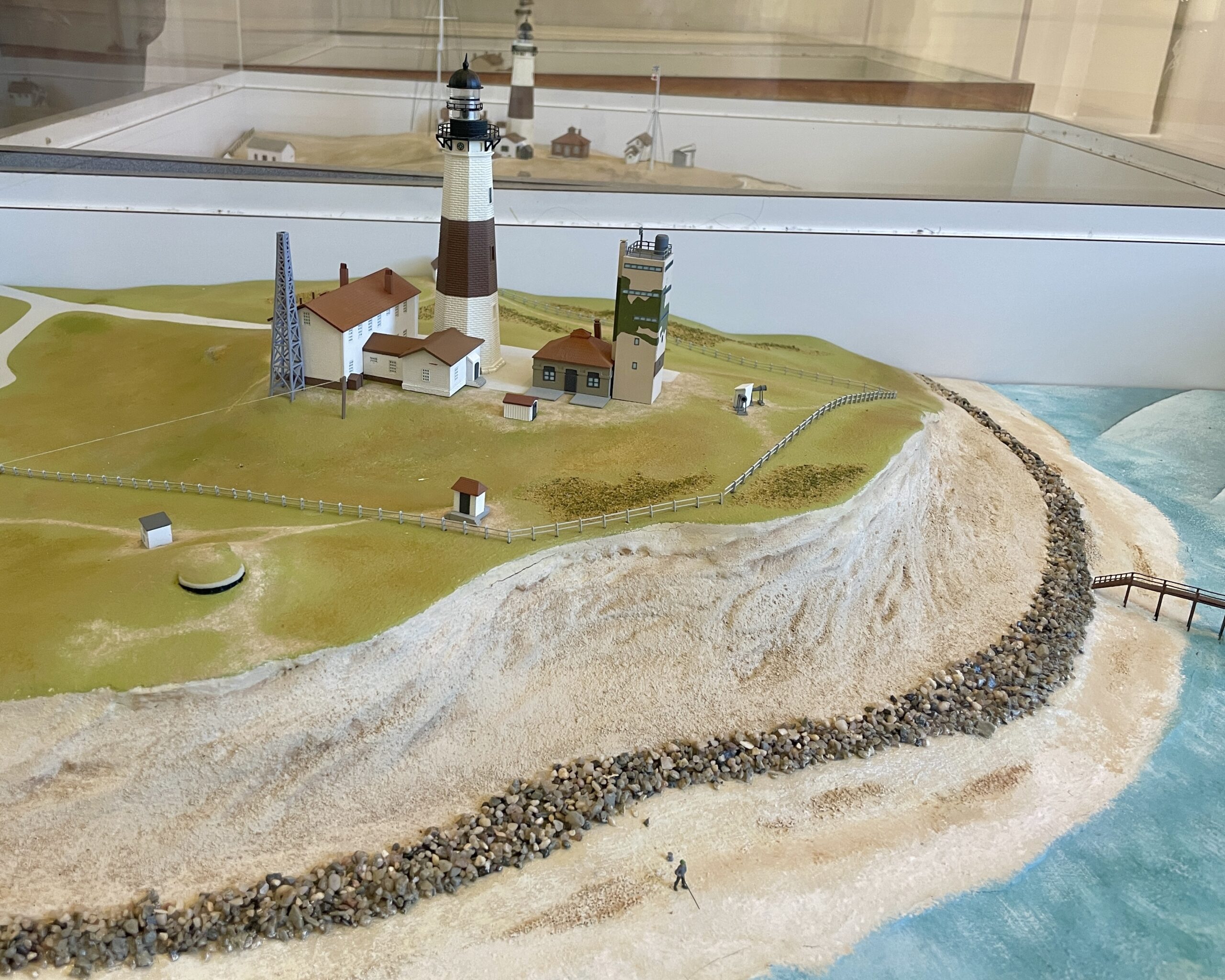 A model of the lighthouse property in the post-WWII days shows the pillbox when it was buried in the bluff along the lighthouse property's southern edge. Built in 1943, by 1976, erosion had exposed the pillbox and its foundation.