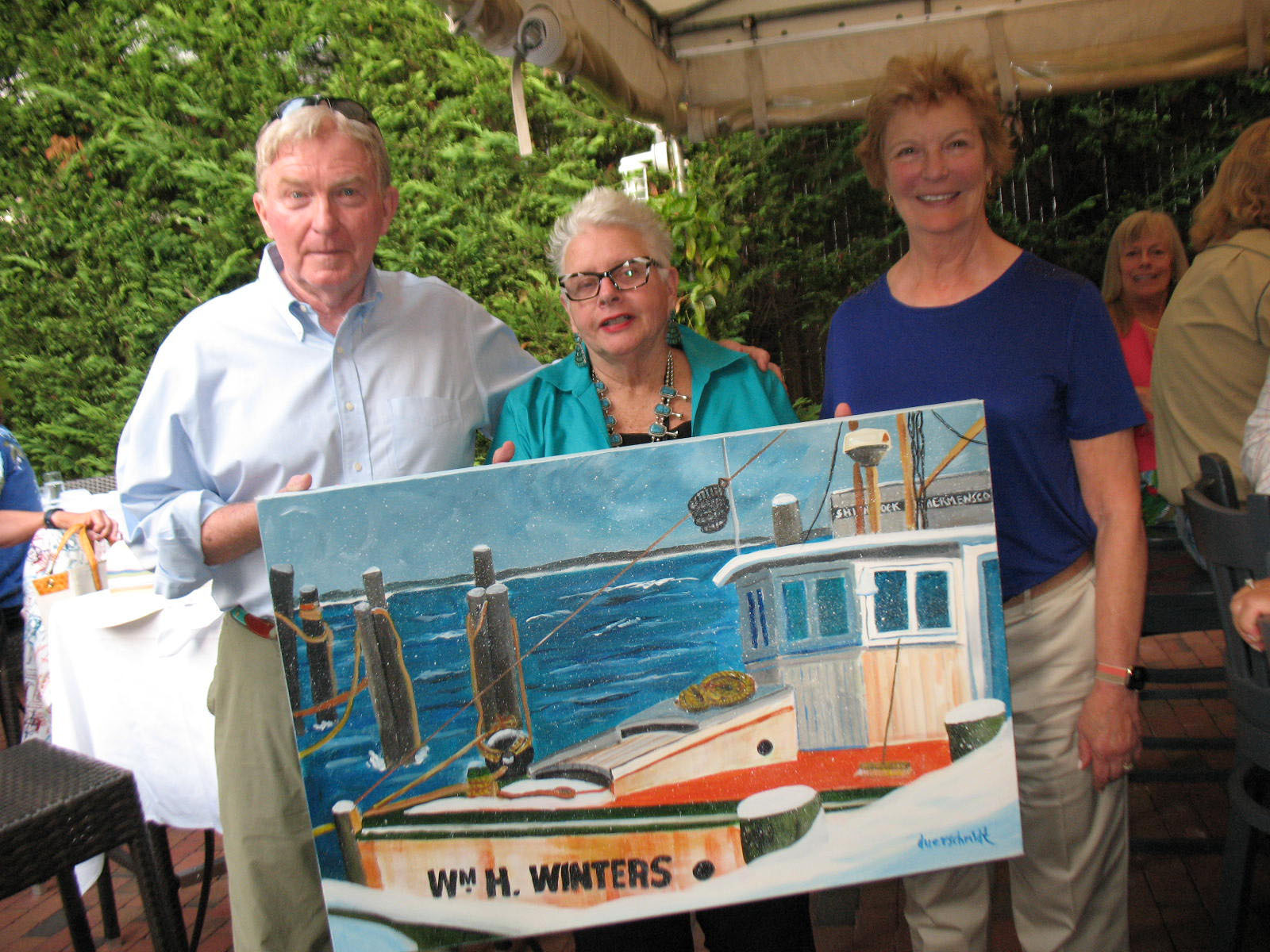 Live auction winners Michael O’Neill and Gail O’Neill with artist Liz Duerschmiet, center,  at 