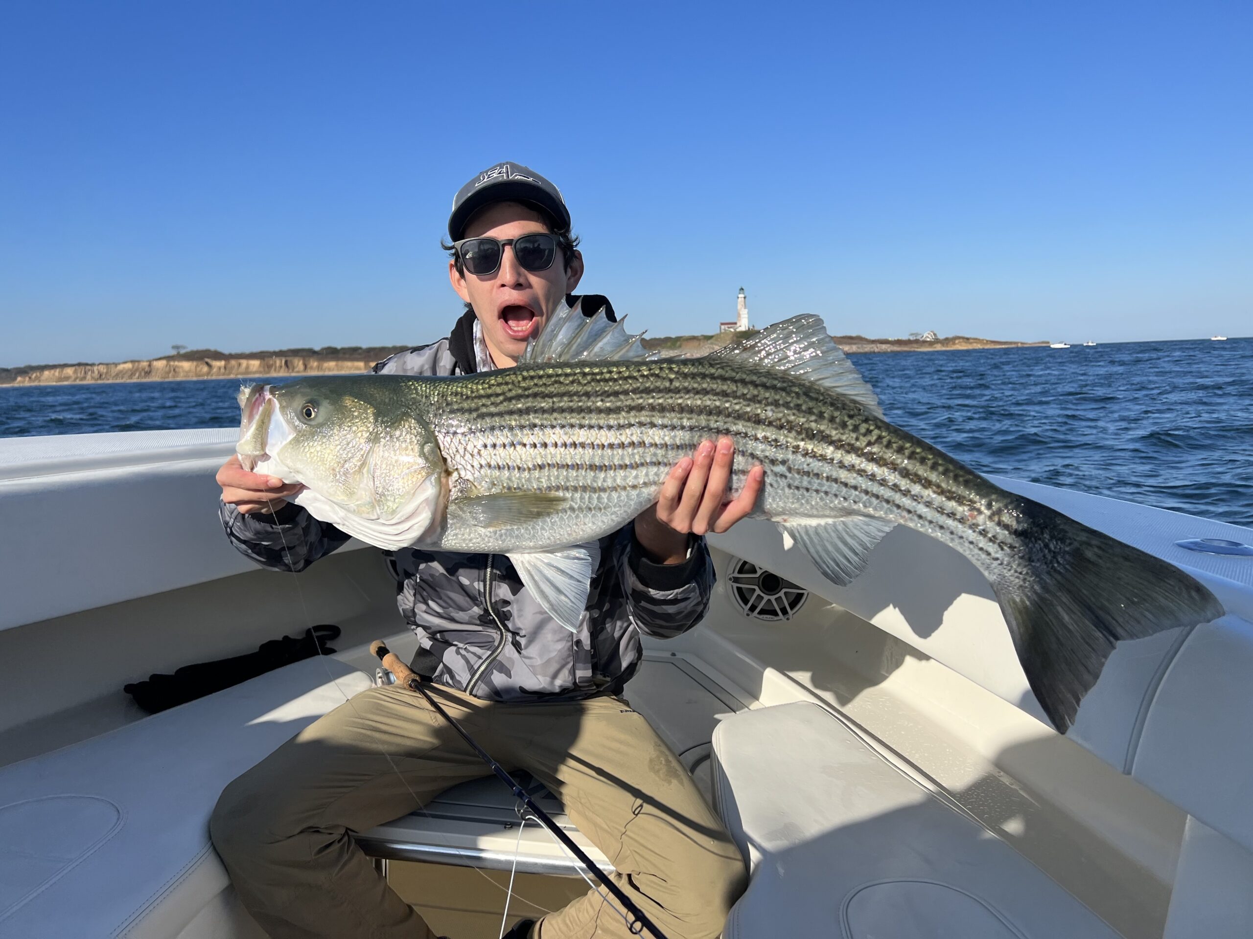 Belli Chou with his largest striper on fly, a 30 pounder caught near the lighthouse last week.    LUYEN CHOU