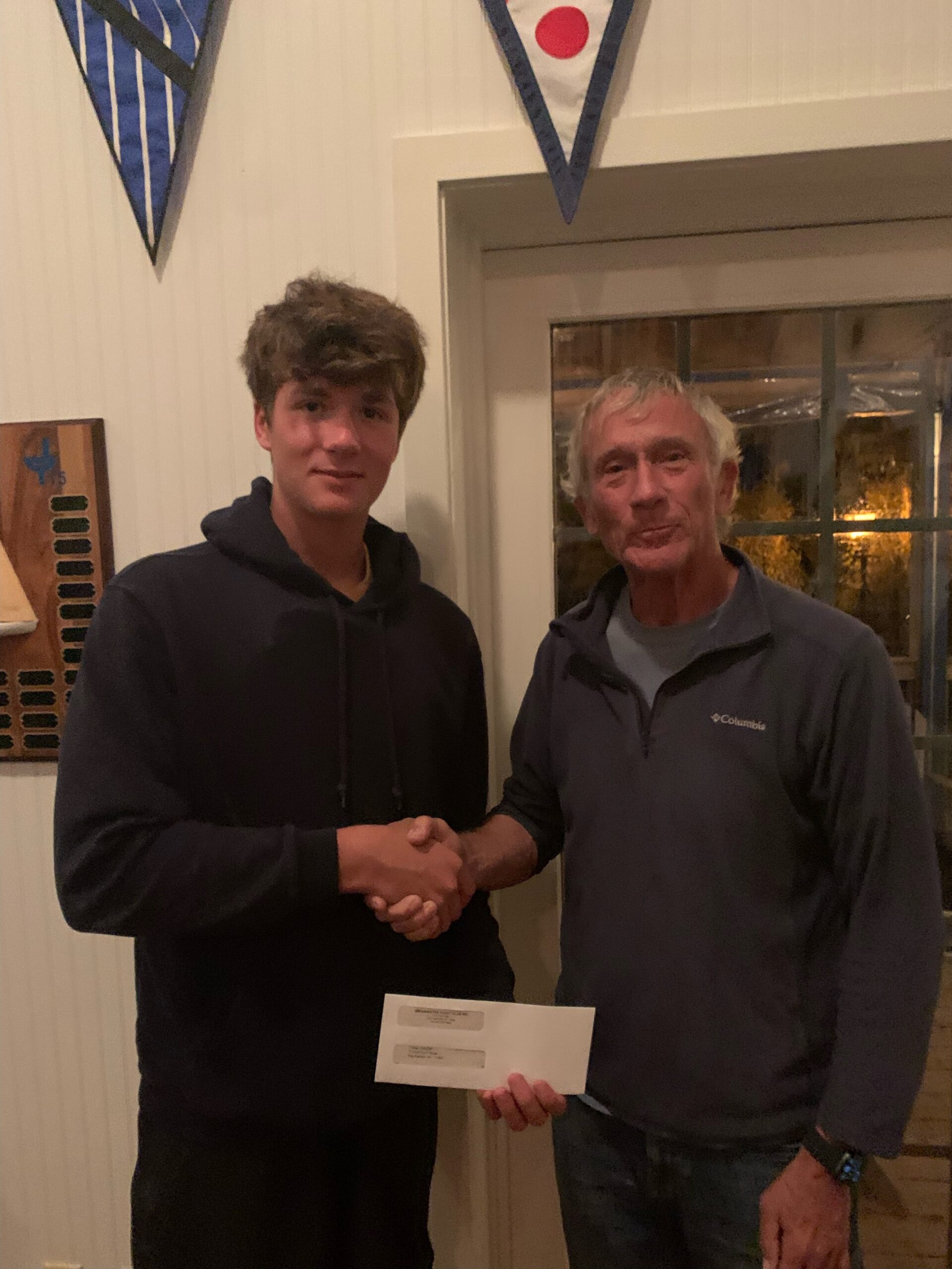 Breakwater Yacht Club Commodore Buddy Rodgers and scholarship winner Tristan Sabbeth.