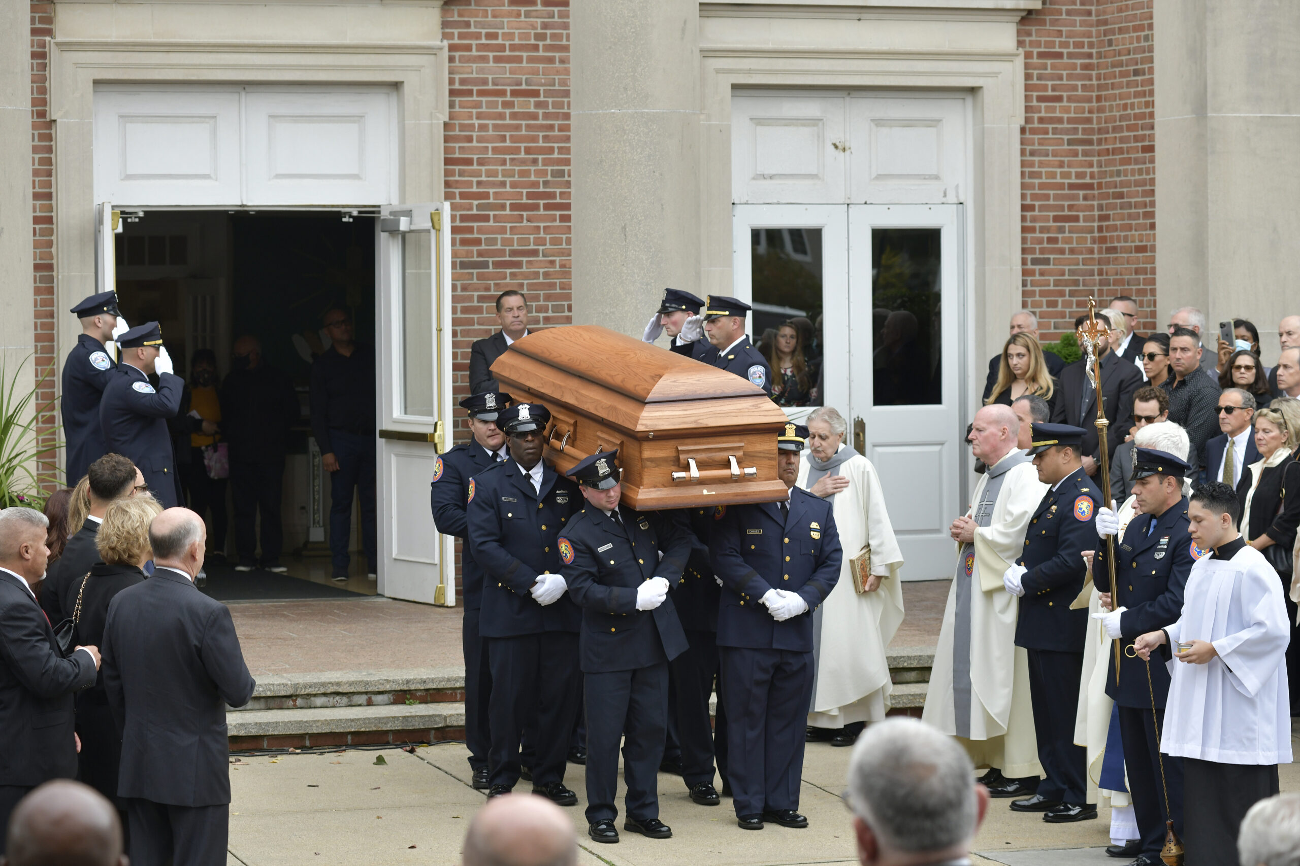 Pallbearers carry the casket of Southampton Police Chief Steven Skrynecki from St. Martin of Tours Church in Amityville on October 13.