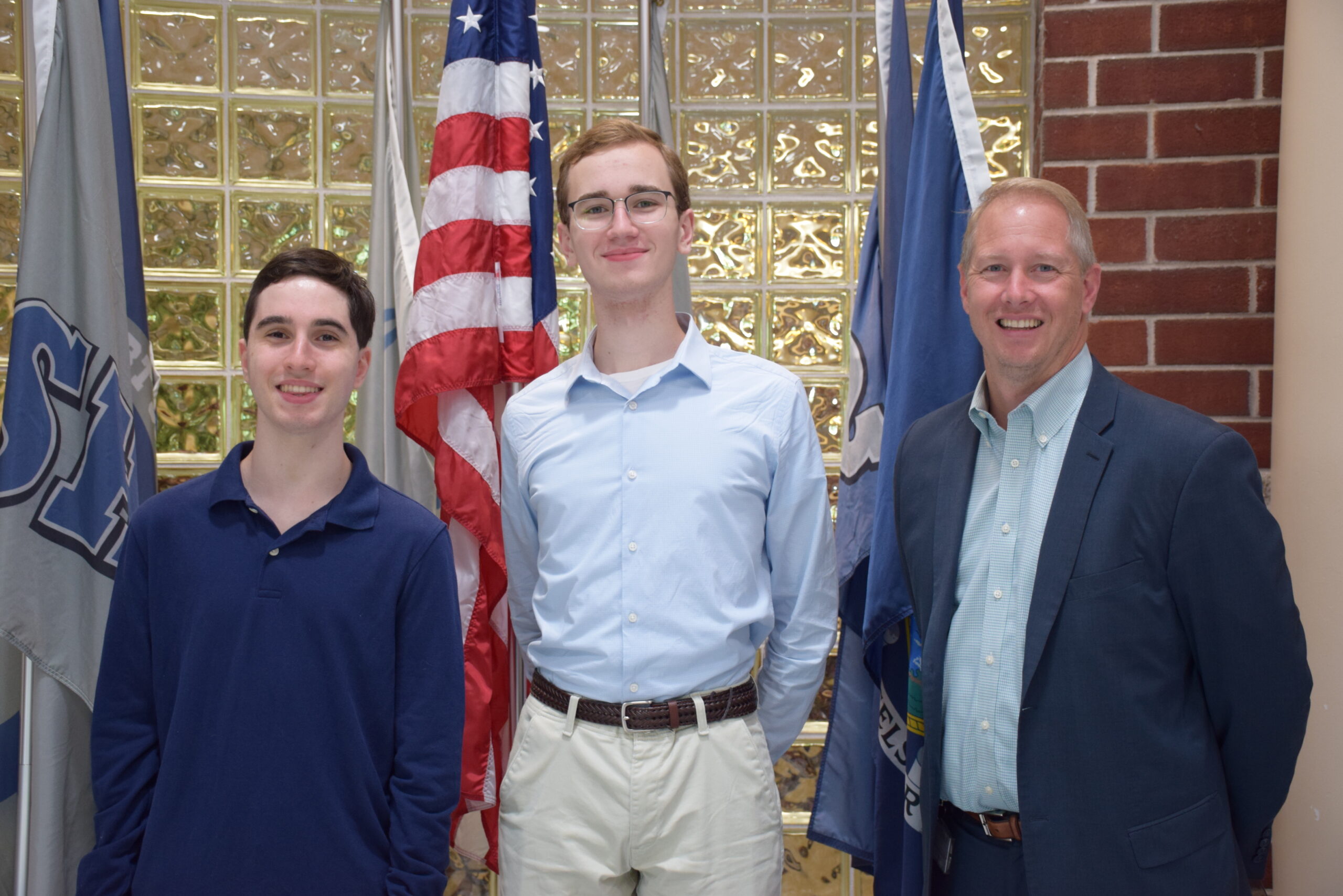 Eastport-South Manor Junior-Senior High School students Benjamin Isaacson, left, and Aidan Young were named National Merit Scholarship Program semifinalists. They are congratulated by Principal Salvatore Alaimo. COURTESY EASTPORT-SOUTH MANOR SCHOOL DISTRICT