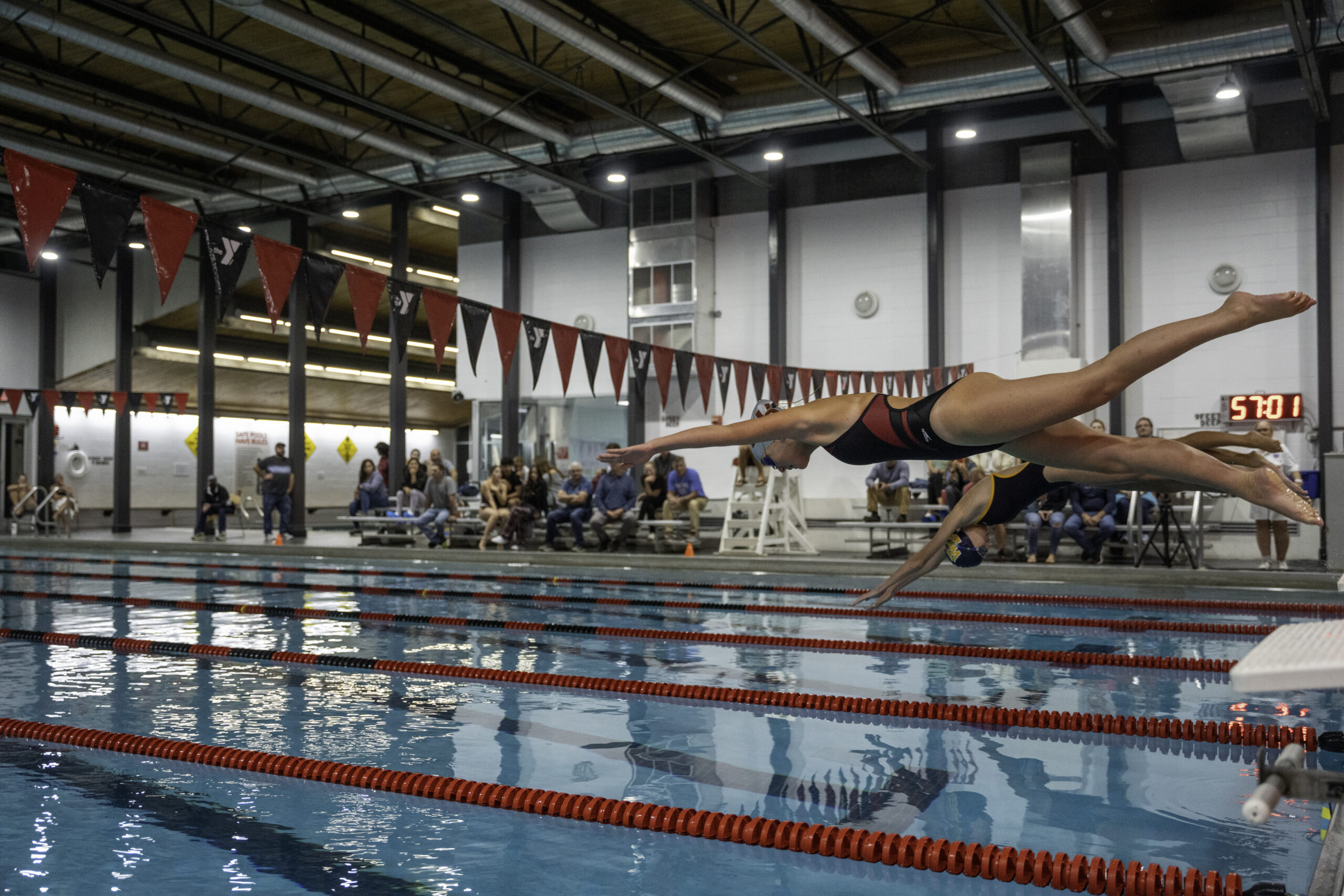 Swimmers jump into the pool at the East Hampton YMCA RECenter during the Bonackers first league meet of the season on September 28.  RON ESPOSITO