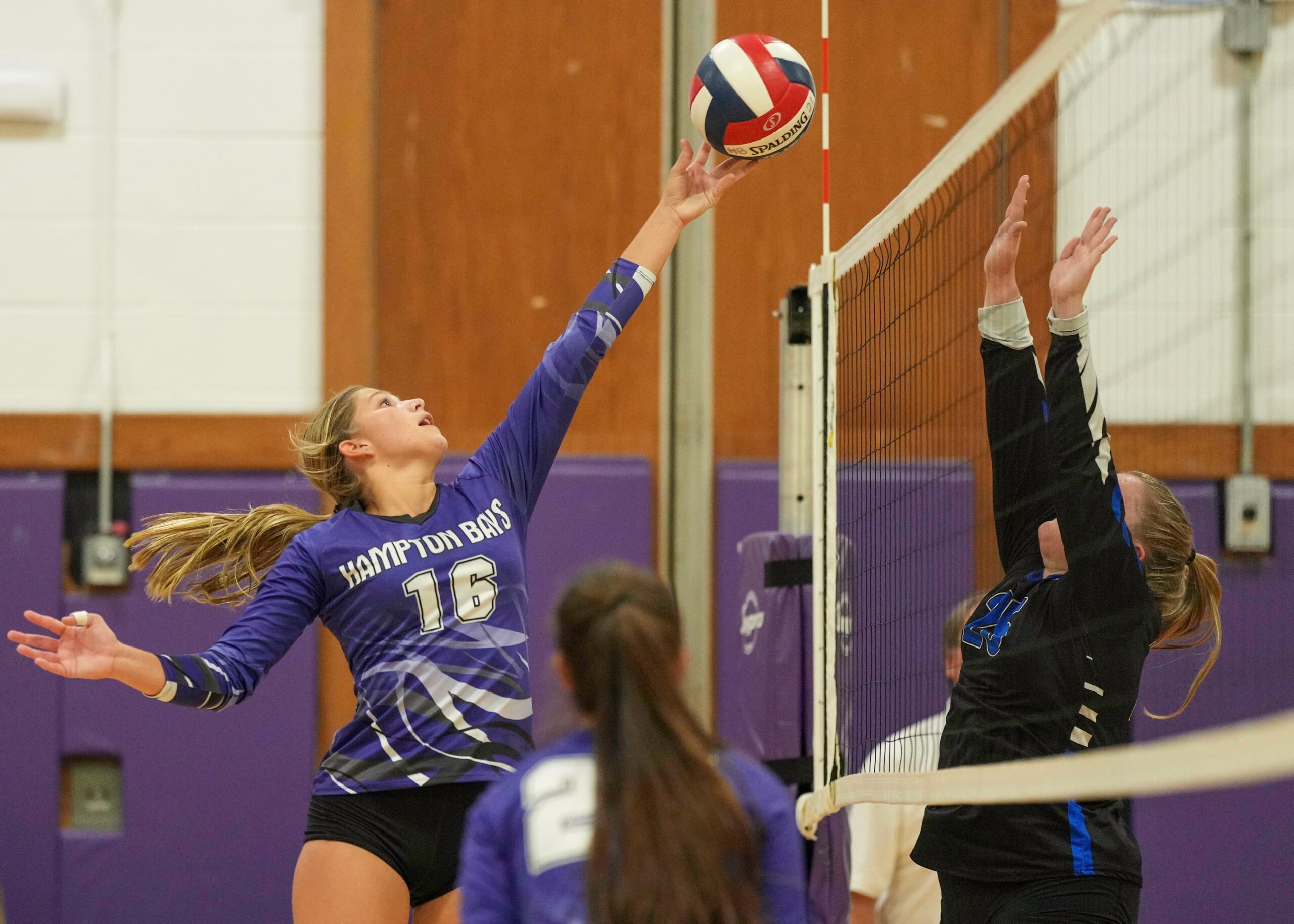 Senior outside hitter Lily Patek tips the ball back over the net. RON ESPOSITO