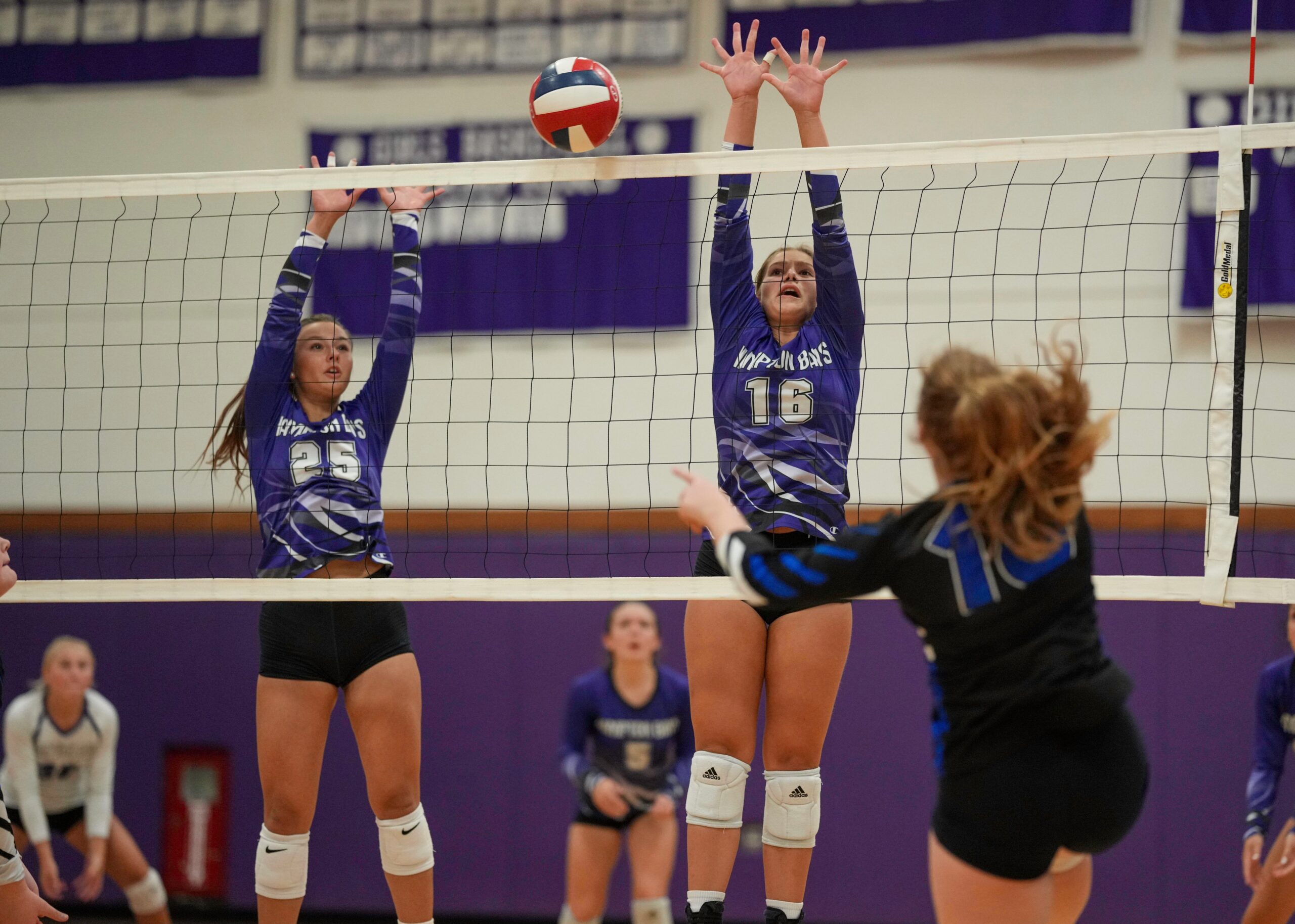 Junior middle blocker Nellie Nicolova and senior outside hitter Lily Patek reach for the ball. RON ESPOSITO