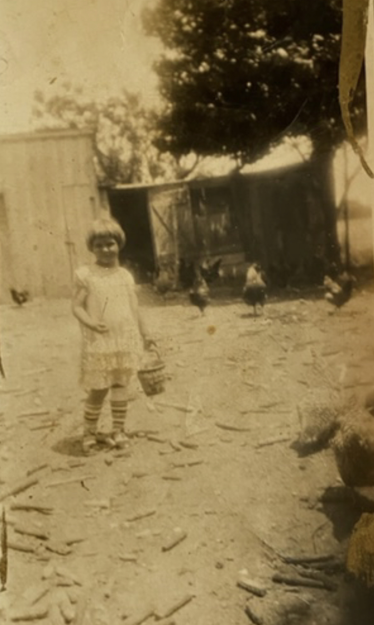A young Frances Kijowski tending to her chickens.