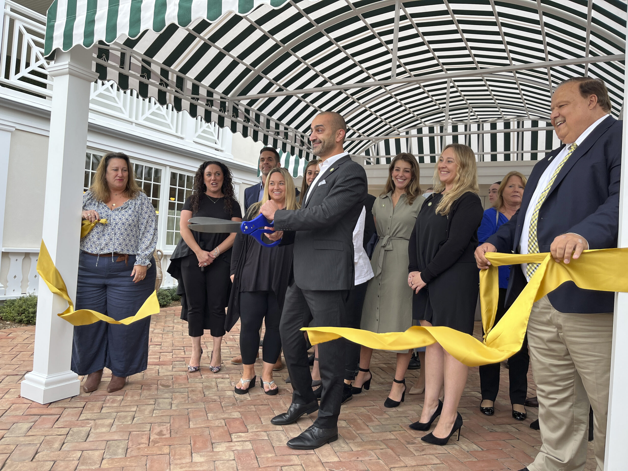 General Manger Mario Arakelian cuts the ribbon at the Canoe Place Inn and Cottages on Thursday afternoon in Hampton Bays. The event was hosted by the Hampton Bays Chamber of Commerce and the Canoe Place Inn.  KEITH SCHULTZ