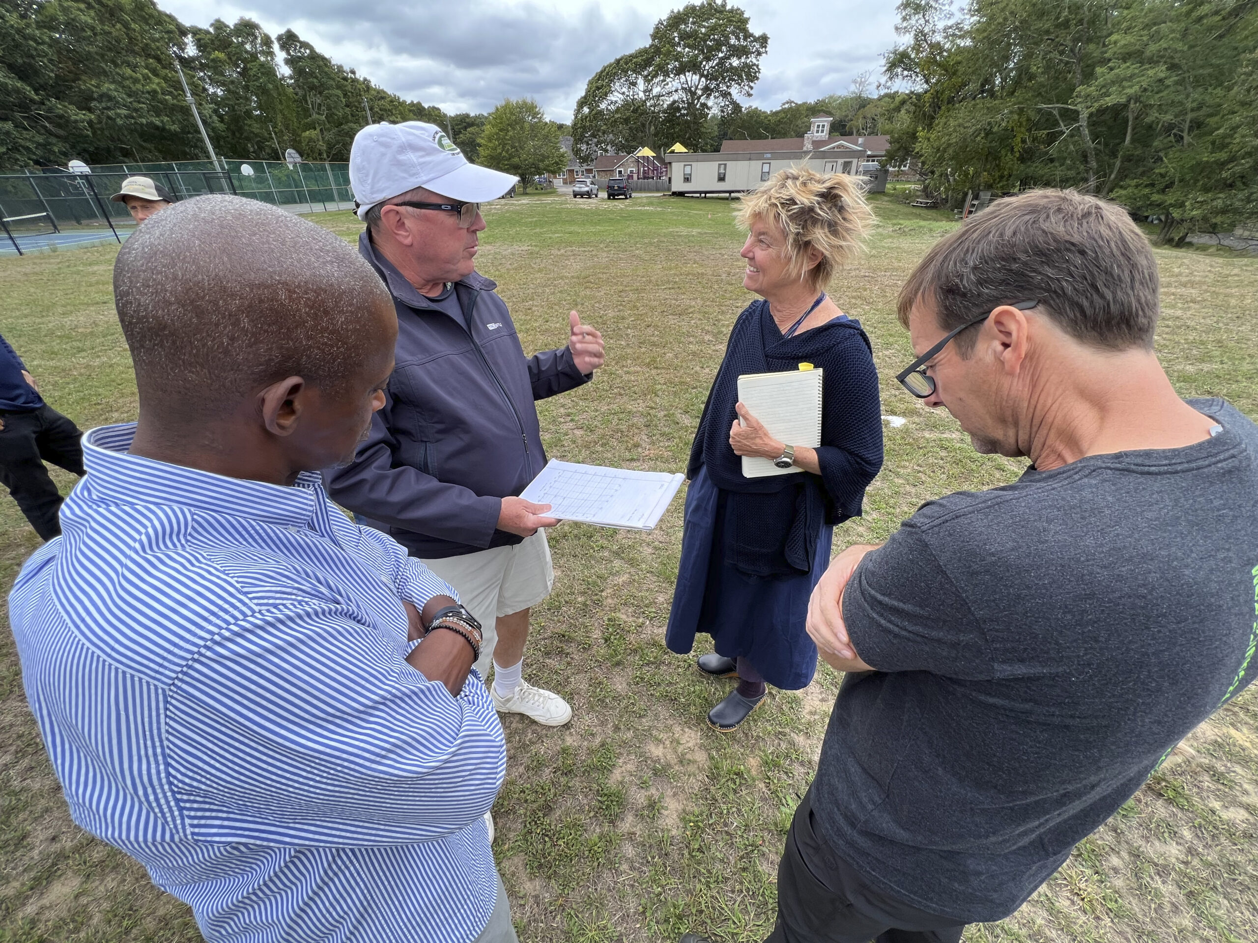 Carl Johnson, Douglas DeGroot, Edwina von Gal and Paul Wagner discuss plans for the Bridgehampton Child Care and Recreational Center field on Friday.  DANA SHAW