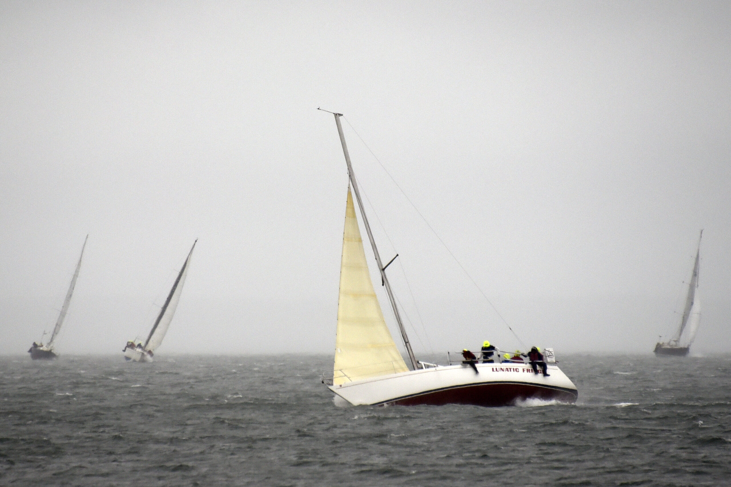Bill Lehnert’s LS-10 Lunatic Fringe fighting the elements in the North Race under jib alone; his main halyard snapped during a gybe minutes after the start.     MICHAEL MELLA