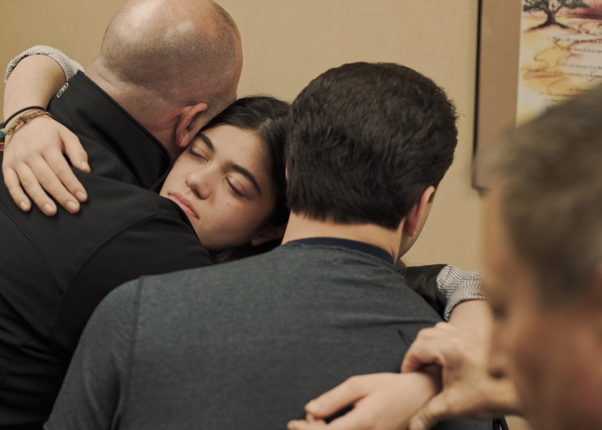 Julie Bruzzese held up by her father and brother in order to have her standing heart rate monitored during an appointment with her Lyme disease specialist, Dr. Richard Horowitz. COURTESY THE QUIET EPIDEMIC