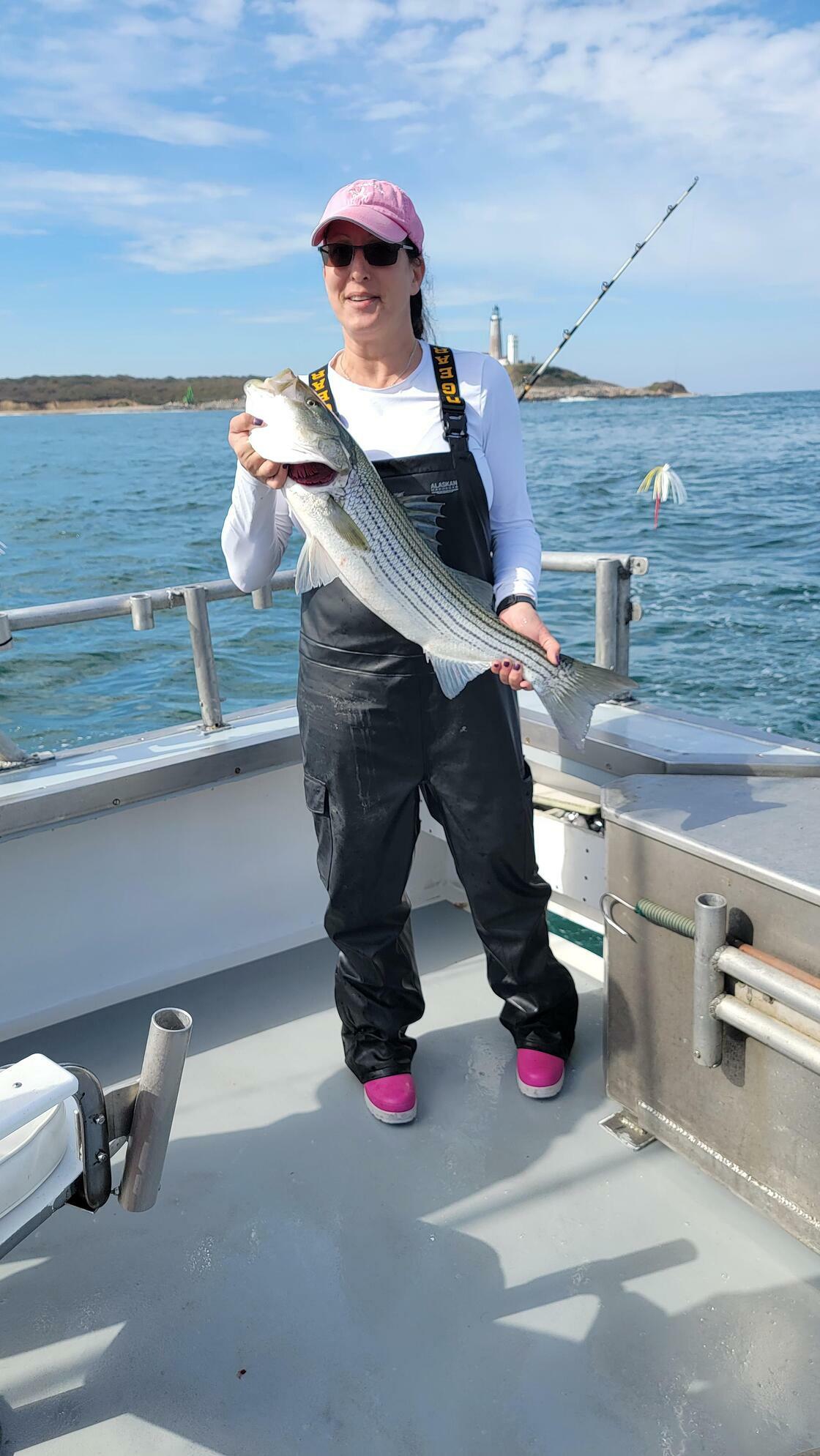 Ilyssa Meyer with a striped bass caught during a recent outing of the East Hampton Sportsmen's Alliance.