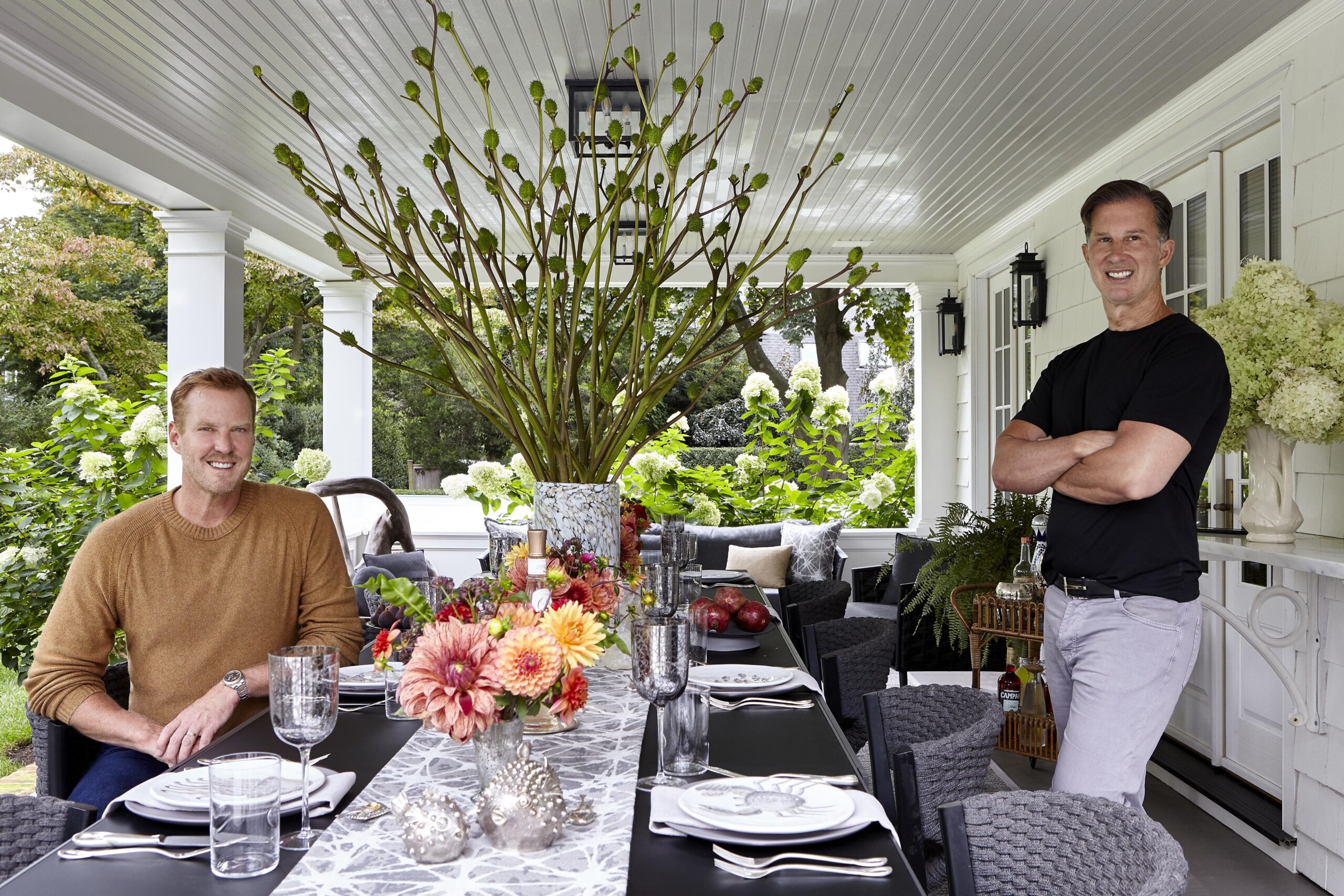 Eric Gunhus and Howard Williams on the dining porch of their East Hampton home. JOSHUA McHUGH