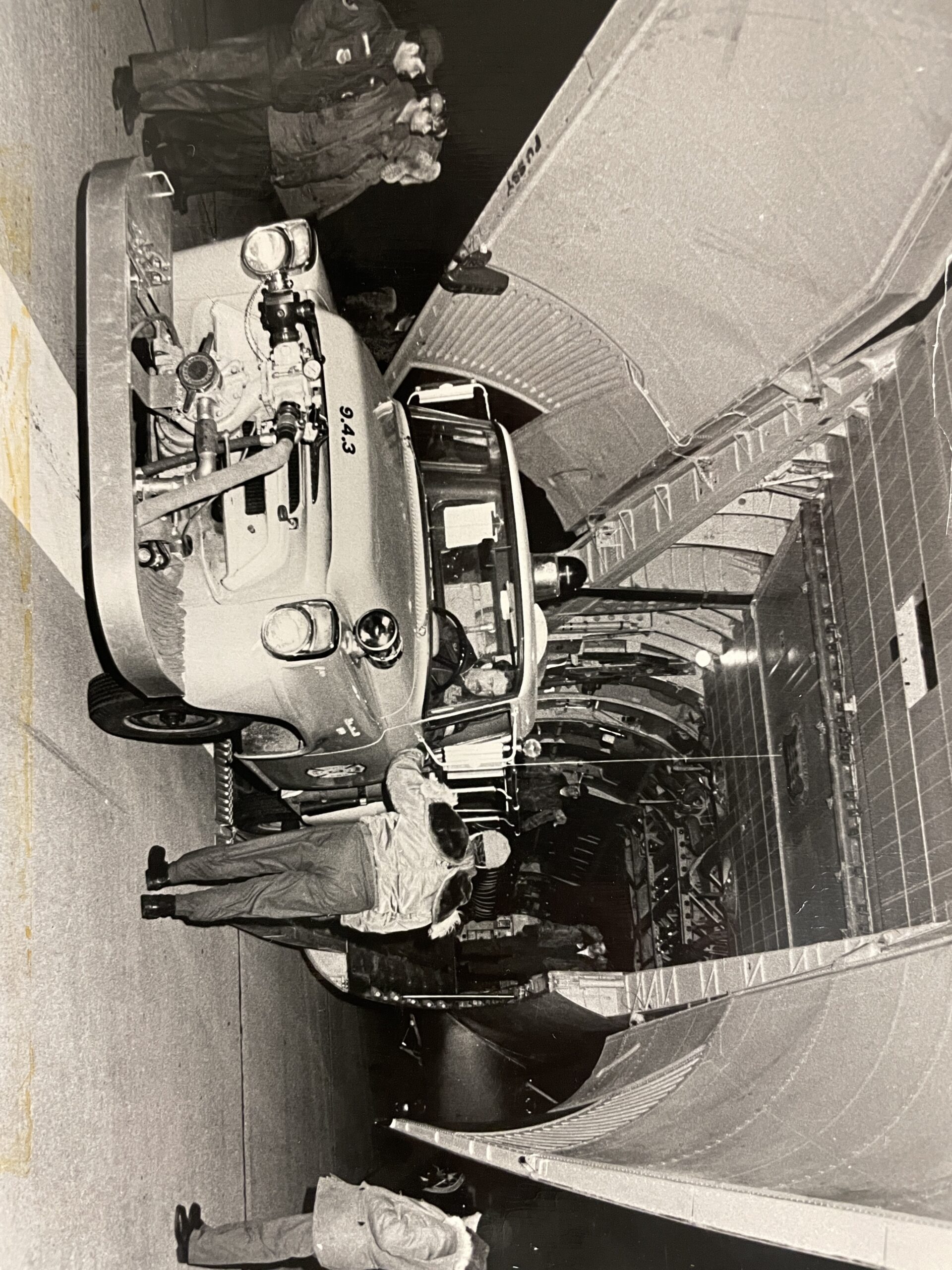 Bob Davis behind the wheel of a Springs Fire Department fire truck in 1977 as it is loaded onto a military plane in Westhampton, part of an airlift of local volunteer fire crews who went to Buffalo to help the city cope with a severe blizzard that buried fire hydrants and stranded many of the city's fire trucks.