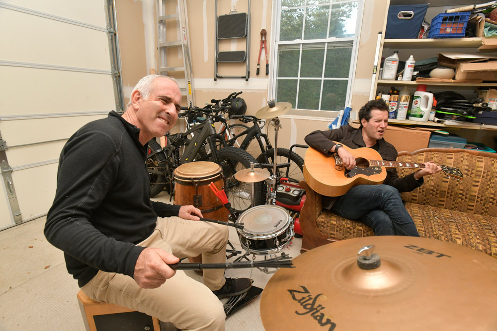 Southampton Town Supervisor Jay Schneiderman and Grammy-nominated musician Matt White practice in Schneiderman's garage. DANA SHAW