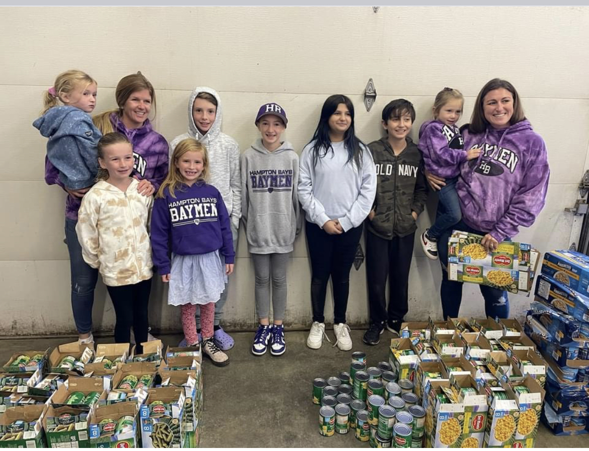 Members of the Hampton Bays Middle School Builder’s Club recently collaborated with the Kiwanis Club of Southampton to prepare thanksgiving food baskets for local food pantries. In total, 100 baskets were assembled for families in need. COURTESY HAMPTON BAYS SCHOOL DISTRICT