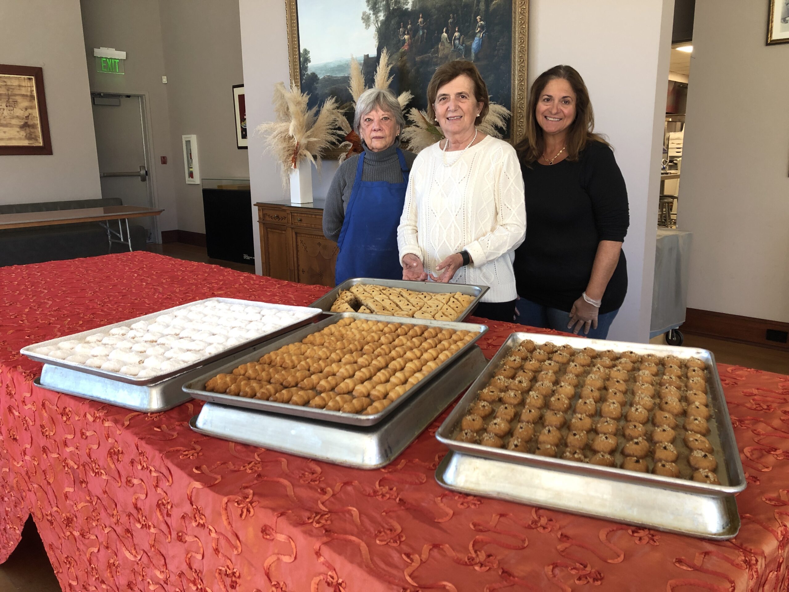 From left, parishioners Isabel Shoukas, Xanthi Karloutsos, and Maria Hatgistavrou are part of a group of mostly women who devote a significant amount of their time to making the pastries and cookies in the church's industrial kitchen. CAILIN RILEY