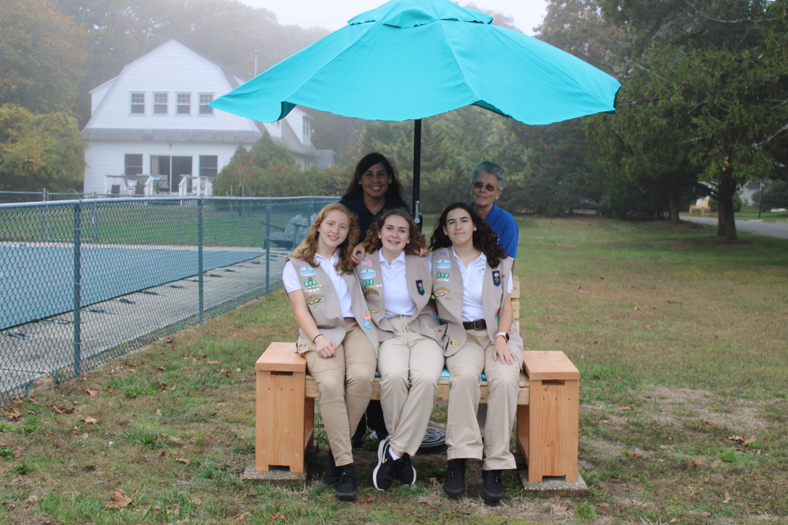 Brianna Farrell, Caitlyn Lupia, Sarah Chami, Sister Kerry Handal CSJ and Laura Farrell with one of the benches the troop built for the Nun's at St. Joseph's Villa. ELIZABETH VESPE