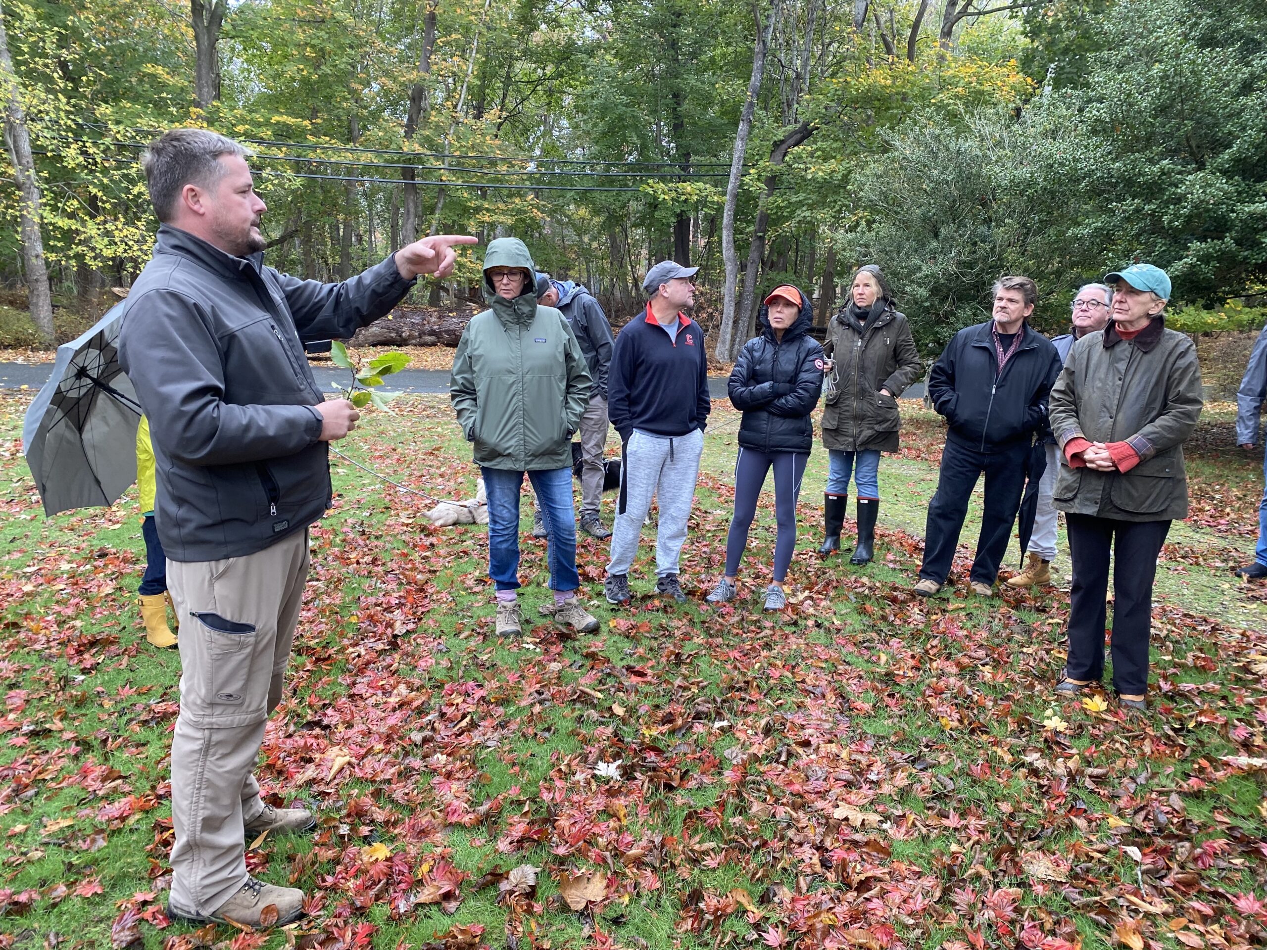 A group of about 25 North Haven residents went on a tree tour of the Lovelady Powell park on a cool, drizzly Sunday led by Jackson Dodds (left), the arborist who with landscaper Sam Panton has donated his services to the park project. The walk was organized by the North Haven Parks and Trails Association. PETER BOODY PHOTO