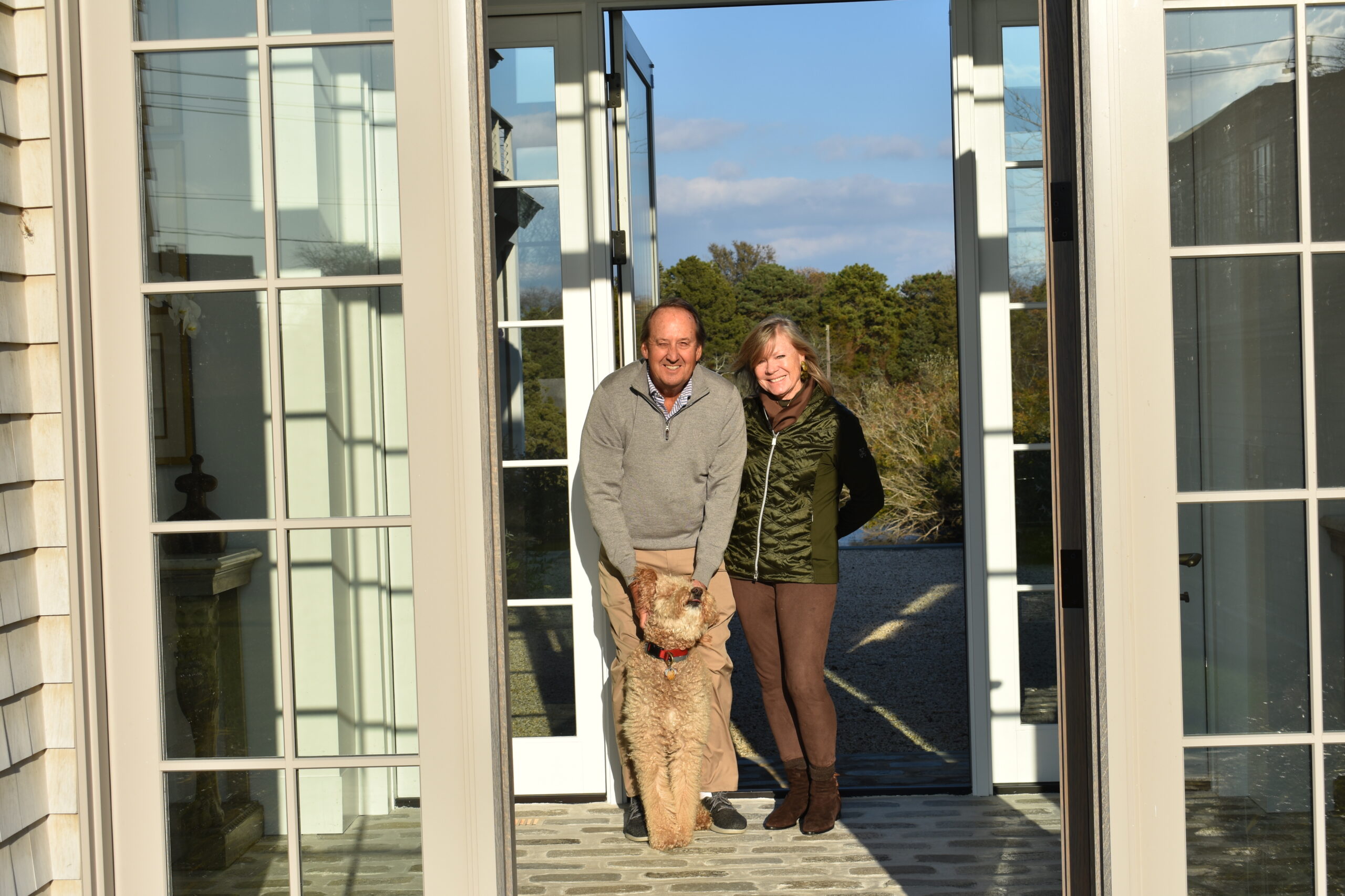 Chester and Christy Murray with their dog, Chewey, in the entrance of their home in Quogue, which will be a stop on the Quogue Historical Society Holiday House tour.