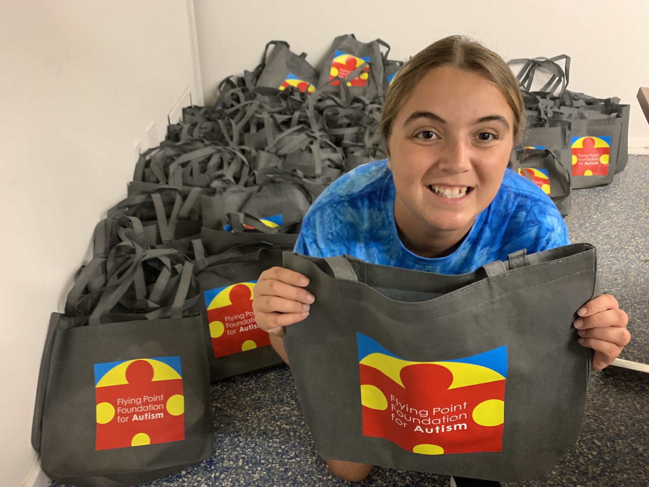 Anna Tuzzolo with the Flying Point Foundation for Autism GoBags she packed for emergency responders. COURTESY FPF.