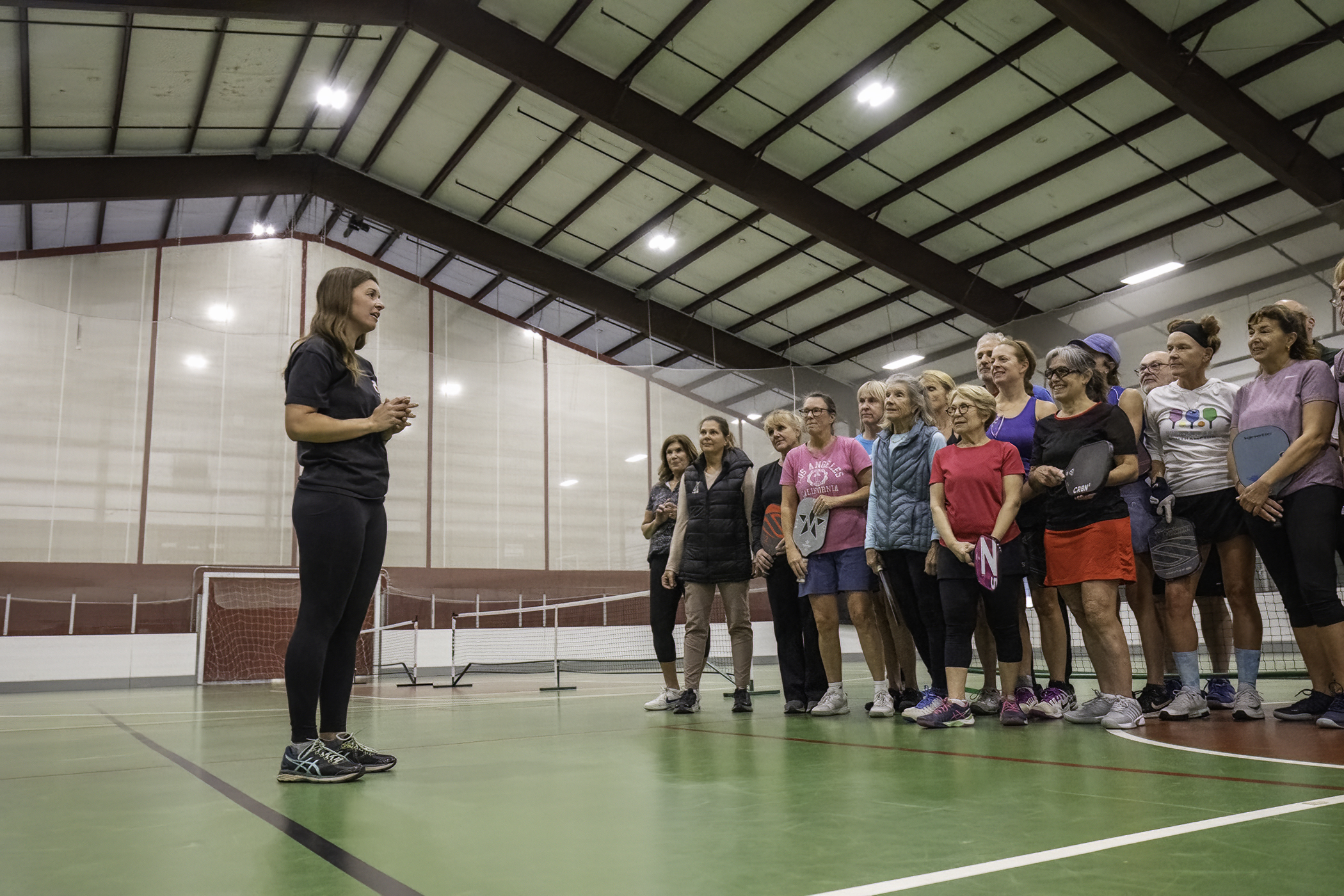 Heart of the Hamptons Executive Director Molly Bishop speaks to the pickleball players on Sunday.    MARIANNE BARNETT