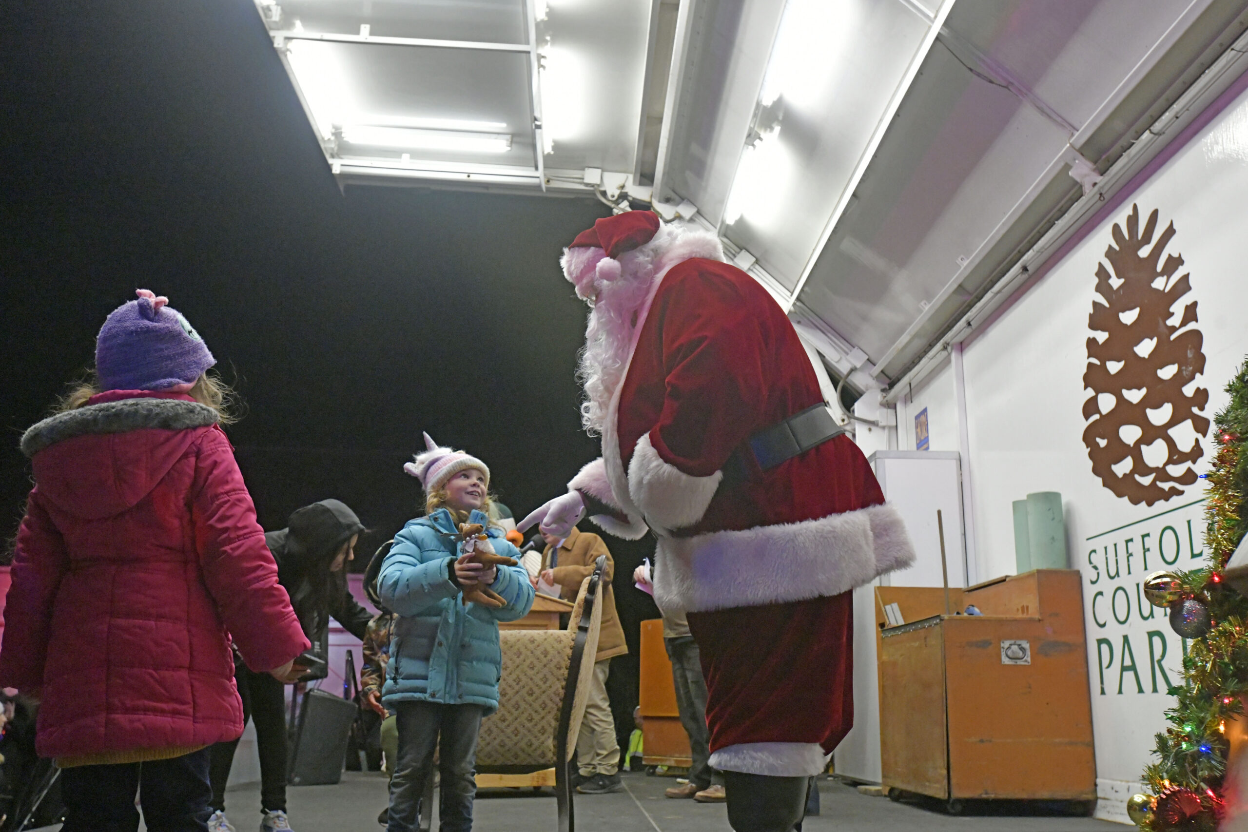 Santa is greeted by young fans.