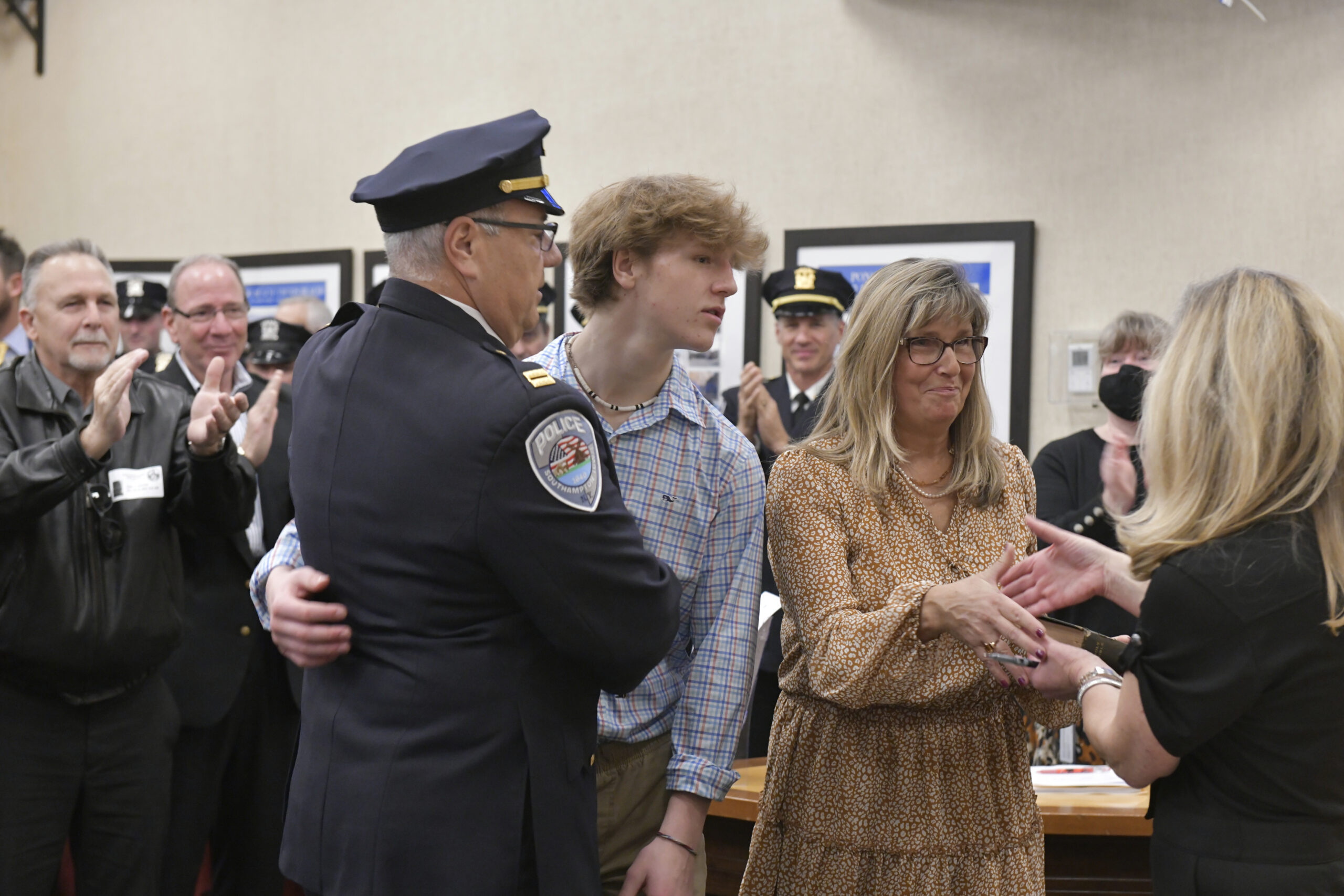 Southampton Town Police Chief James Kiernan is congratulated by his son, Jack, wife Julie and Southampton Town Clerk Sundy Schermeyer.    DANA SHAW