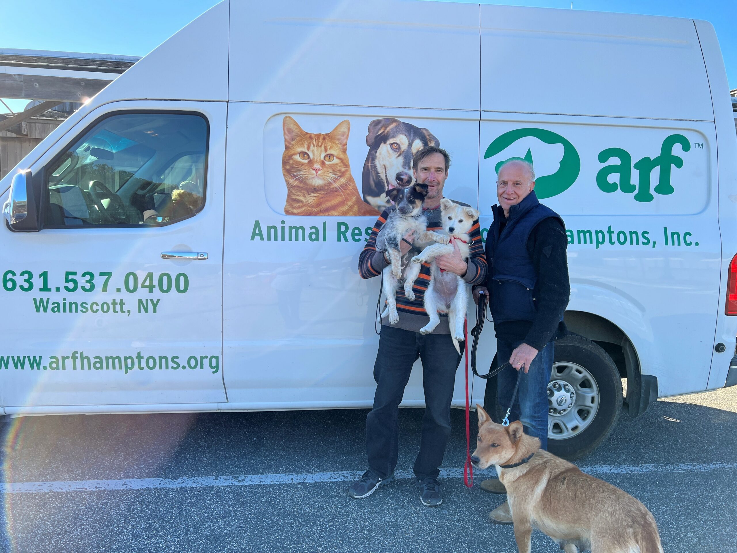 Pilot Dr. George Dempsey holds Blue Corn and Biscochito after he and pilot David Reinbach, with mom Zia, arrived safely from New Mexico with the rescued pups. COURTESY ANIMAL RESCUE FUND OF THE HAMPTONS