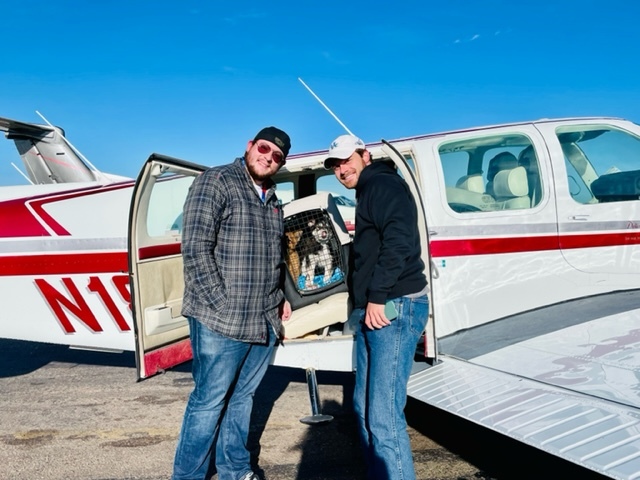 Pilots Jan Brentjens and Matthew Pellegrino pose with the precious cargo. COURTESY ANIMAL RESCUE FUND OF THE HAMPTONS