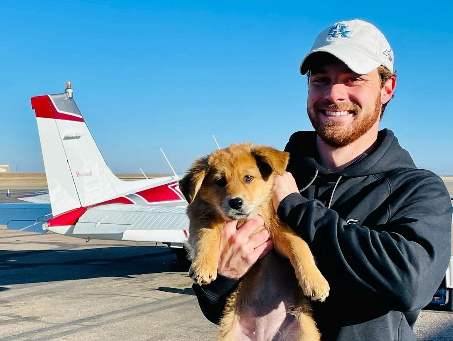 Pilot Matt Pellegrino and a puppy, ready for takeoff. COURTESY ANIMAL RESCUE FUND OF THE HAMPTONS