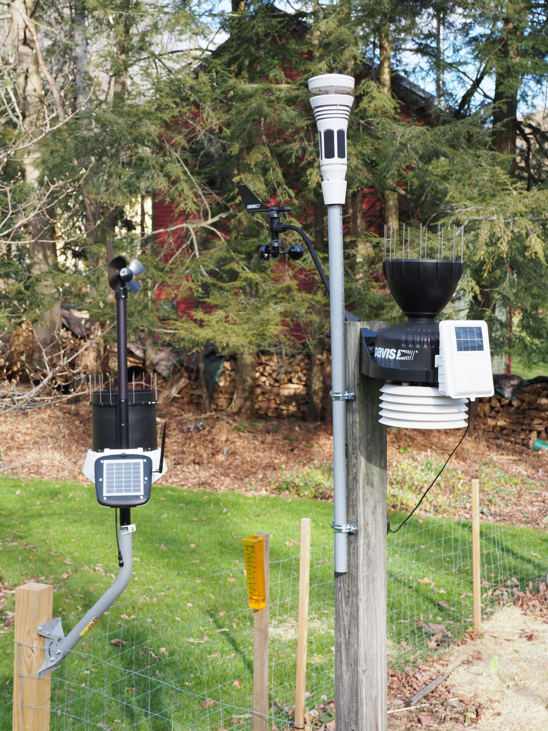 A group portrait. The WS 6000 on the left. One of the two Tempest stations sit atop a rigid plastic pipe and was clearly the easiest to install. On the right side of the same post is the Davis Vantage Pro 2 stations with the rain collector on top, solar collector on the right and naturally aspirated sensor bundle (white) at the bottom. The wind vane and wind cups for the VP 2 areto the left of the Tempest. There was some concern that the VP 2 would create vibrations that the Tempest might pick up and misinterpret. This turned out not to be the case. ANDREW MESSINGER